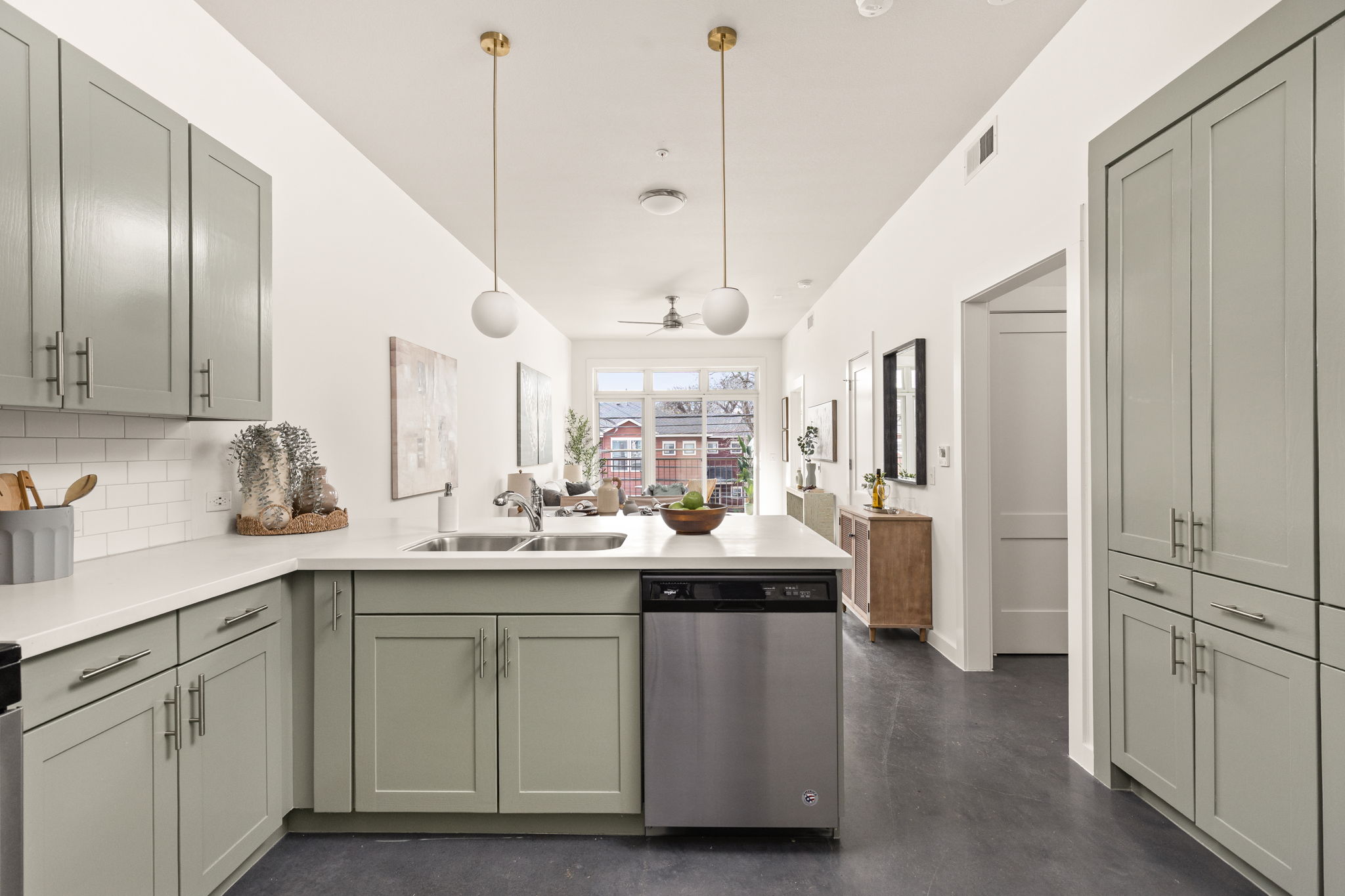 a kitchen with kitchen island white cabinets and stainless steel appliances