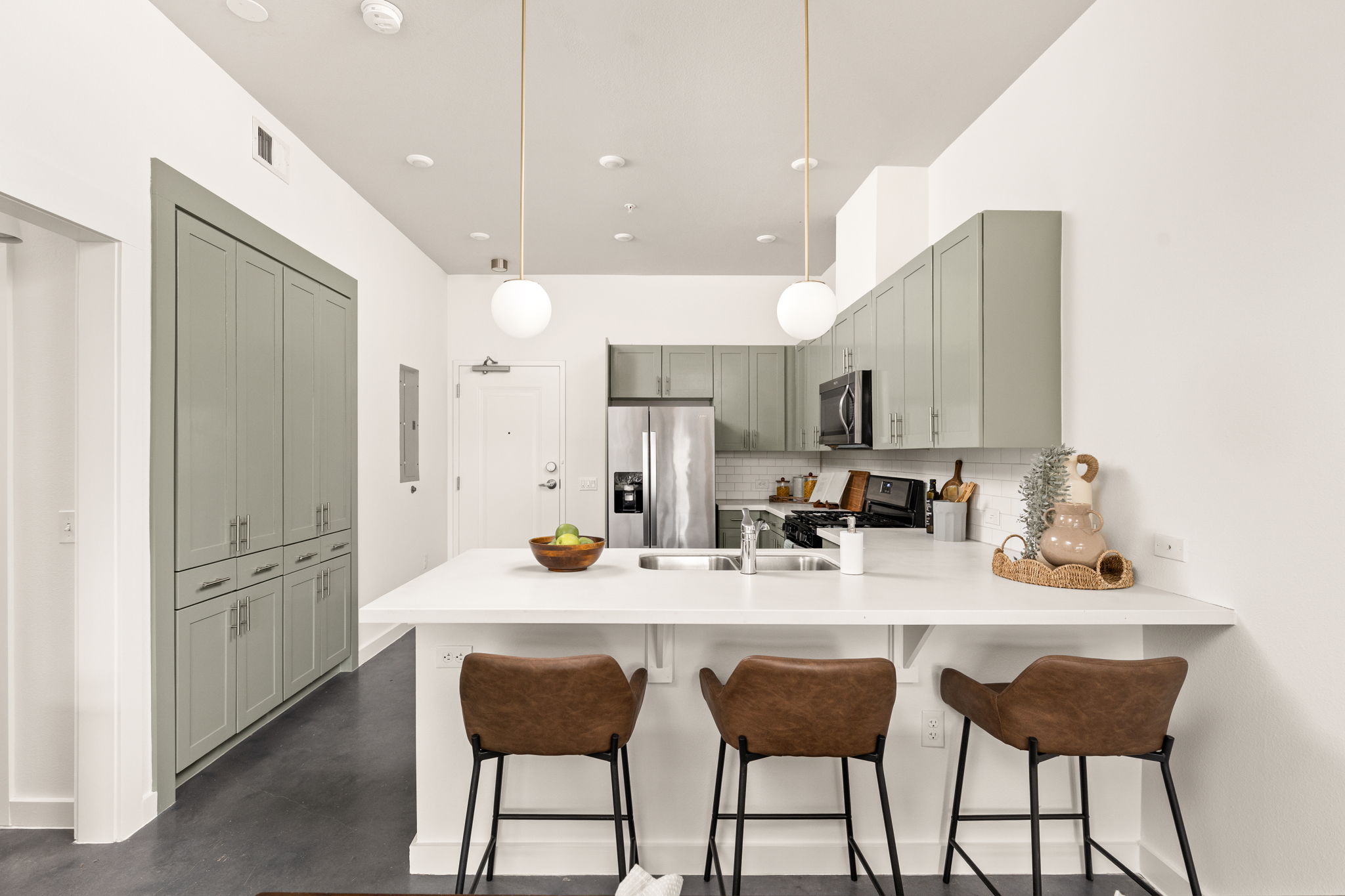 1301 Chicon Street, Unit 203 Austin, TX 78702 - Photo 6 of 27 a kitchen with granite countertop a sink cabinets and refrigerator
