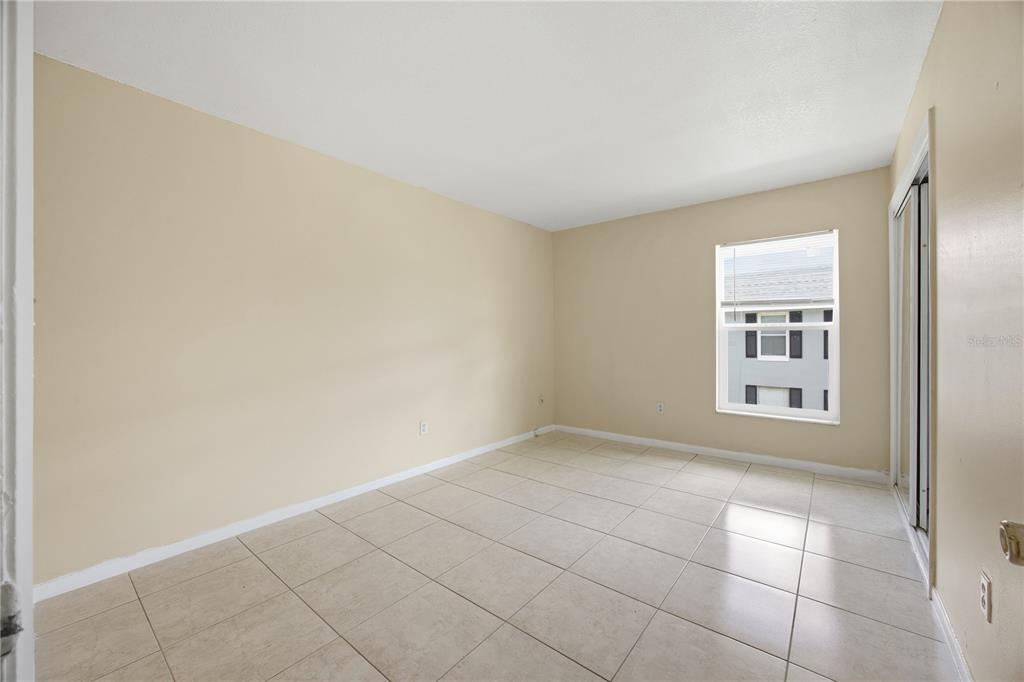925 West Oak Ridge Road, Unit 925C Orlando, FL 32809 - Photo 7 of 15 an empty room with windows