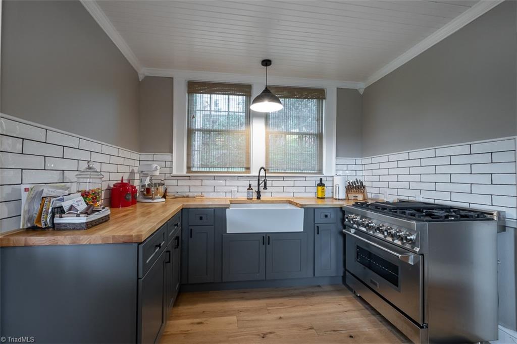 113 Gwyn Avenue Elkin, NC 28621 - Photo 12 of 39 Renovated kitchen with new cabinetry, butcher block counter tops and gas cooktop and oven.