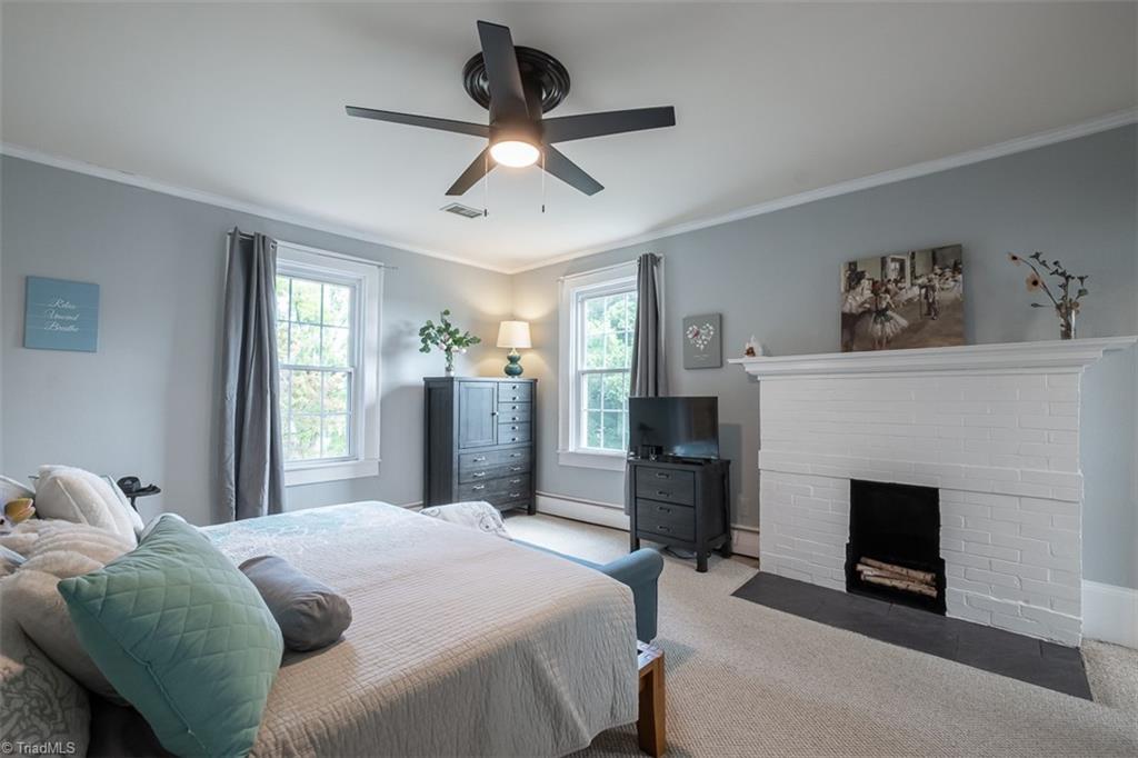 113 Gwyn Avenue Elkin, NC 28621 - Photo 20 of 39 Primary bedroom with decorative fireplace.