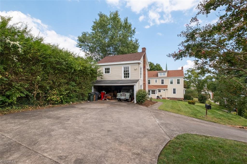 113 Gwyn Avenue Elkin, NC 28621 - Photo 36 of 39 Rear view of home from driveway looking toward detached garage.