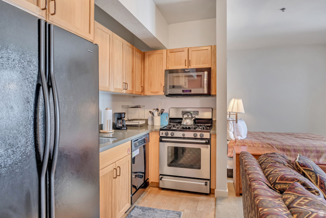 1364 Still Water Drive, Unit R3005 Heber City, UT 84032 - Photo 10 of 28 Kitchen with black appliances, light wood finish cabinetry, and light wood-style flooring