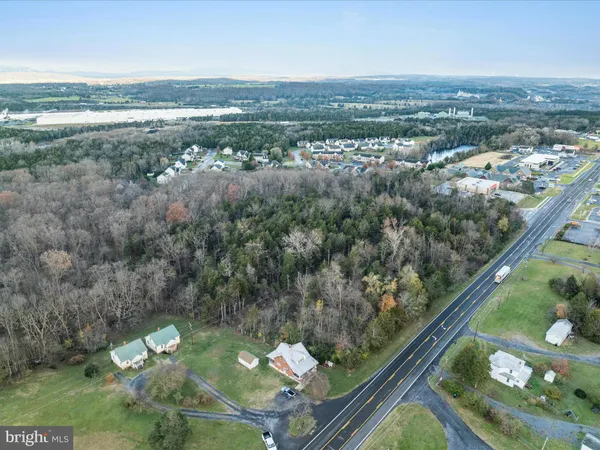 an aerial view of lake and residential houses with outdoor space