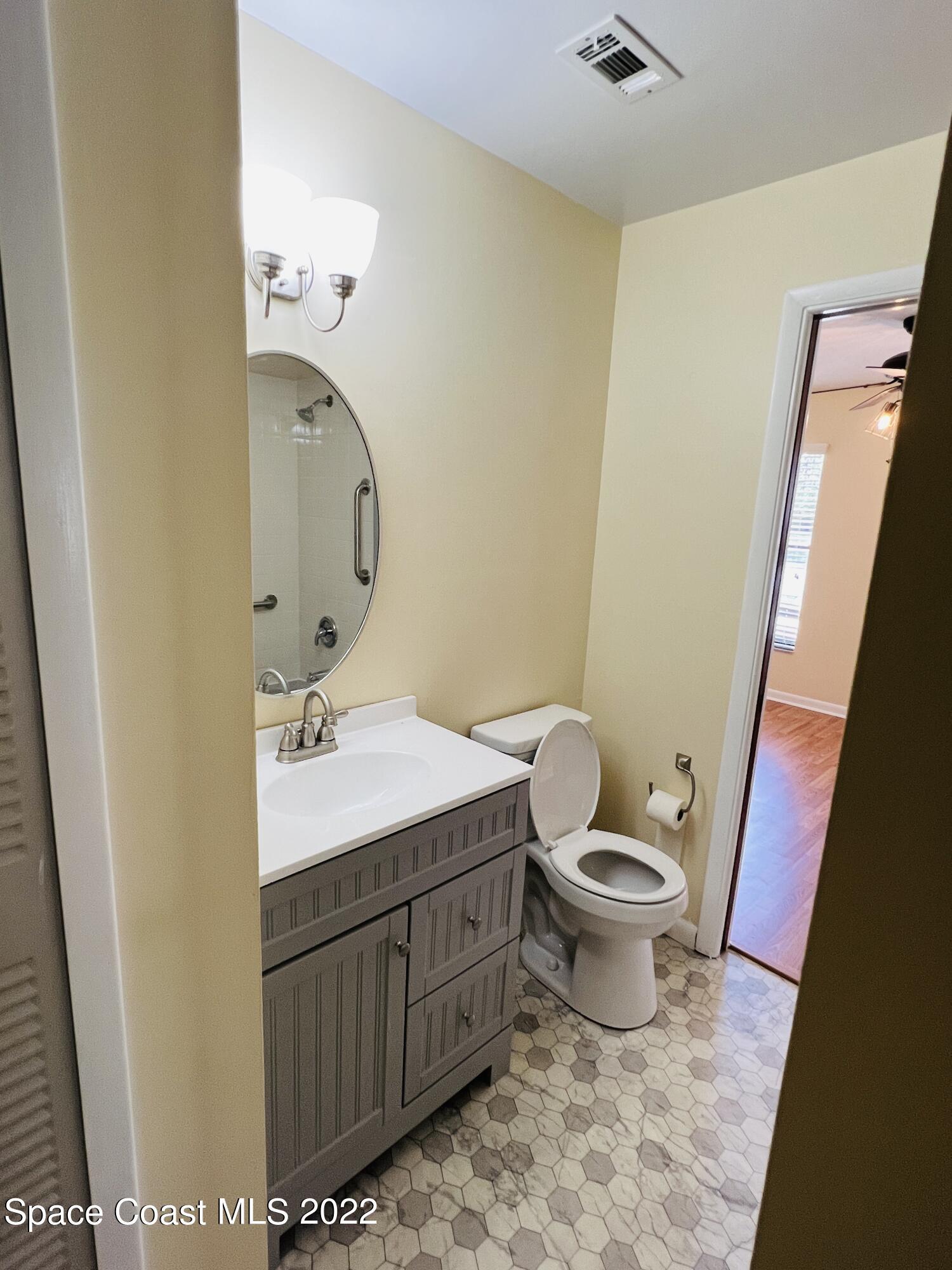 4897 Bridge Road Cocoa, FL 32927 - Photo 7 of 12 a bathroom with a sink toilet and mirror