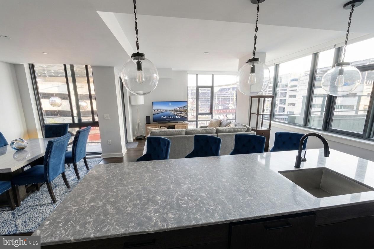 a large kitchen with kitchen island a large counter top space appliances and cabinets
