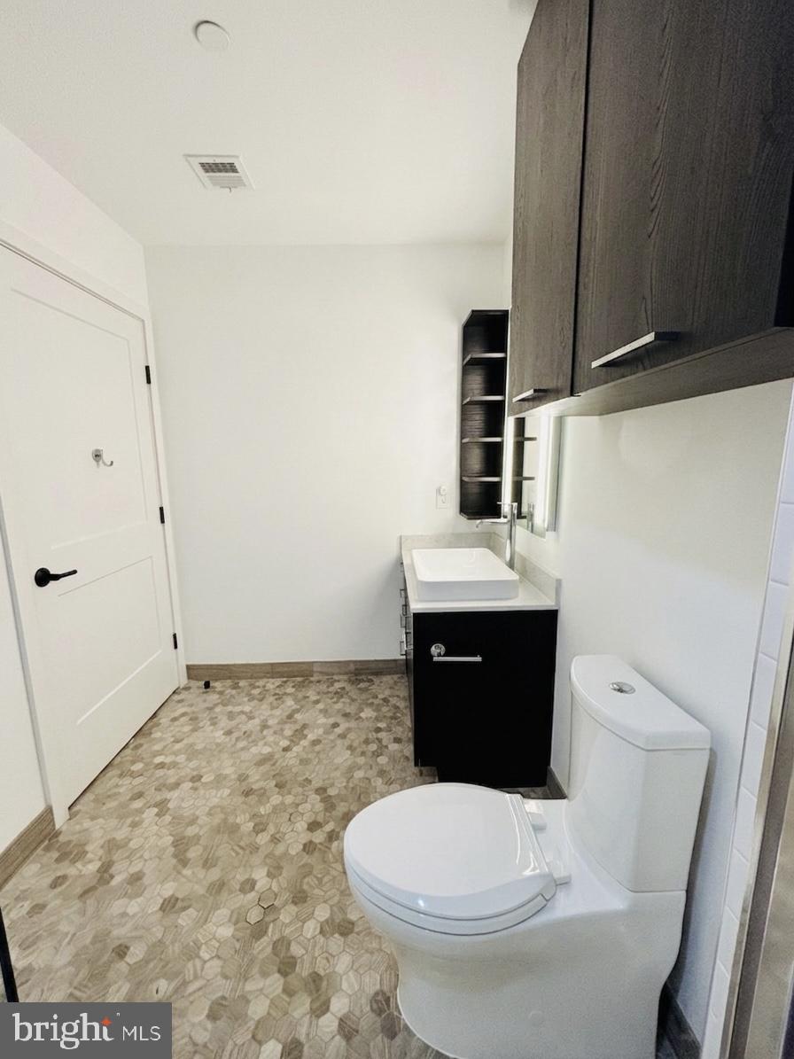 70 N Street Southeast, Unit N301 Washington, DC 20003 - Photo 17 of 47 a bathroom with a sink a toilet and shower