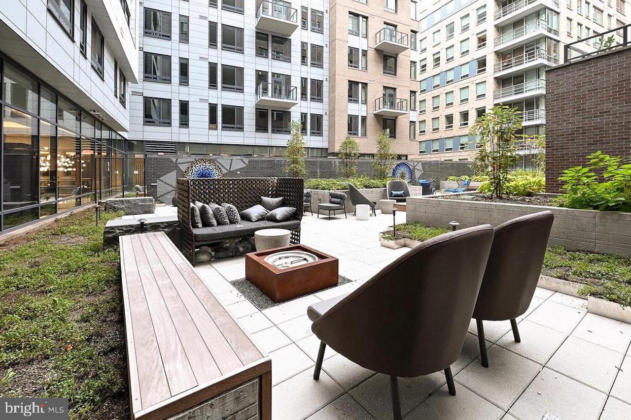 70 N Street Southeast, Unit N301 Washington, DC 20003 - Photo 29 of 47 a view of a swimming pool with outdoor seating and plants