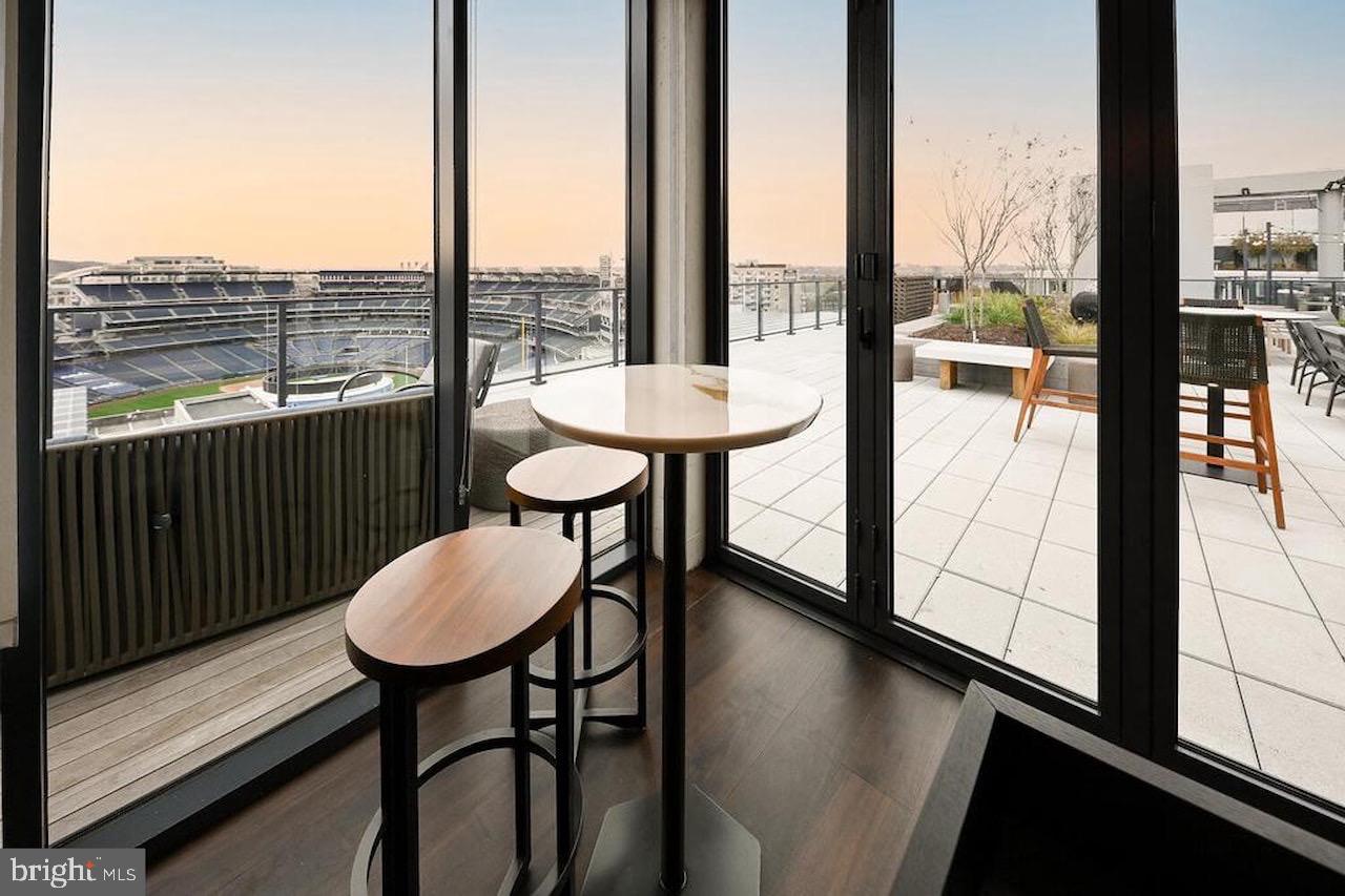 70 N Street Southeast, Unit N301 Washington, DC 20003 - Photo 32 of 47 a view of a room with a table chairs and balcony