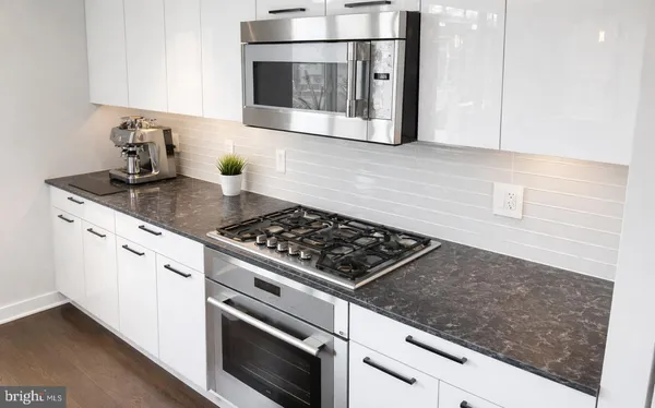 a stove top oven sitting inside of a kitchen