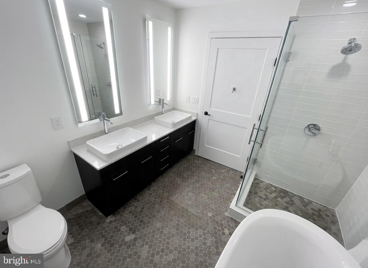 70 N Street Southeast, Unit N301 Washington, DC 20003 - Photo 9 of 47 a bathroom with a sink and a mirror