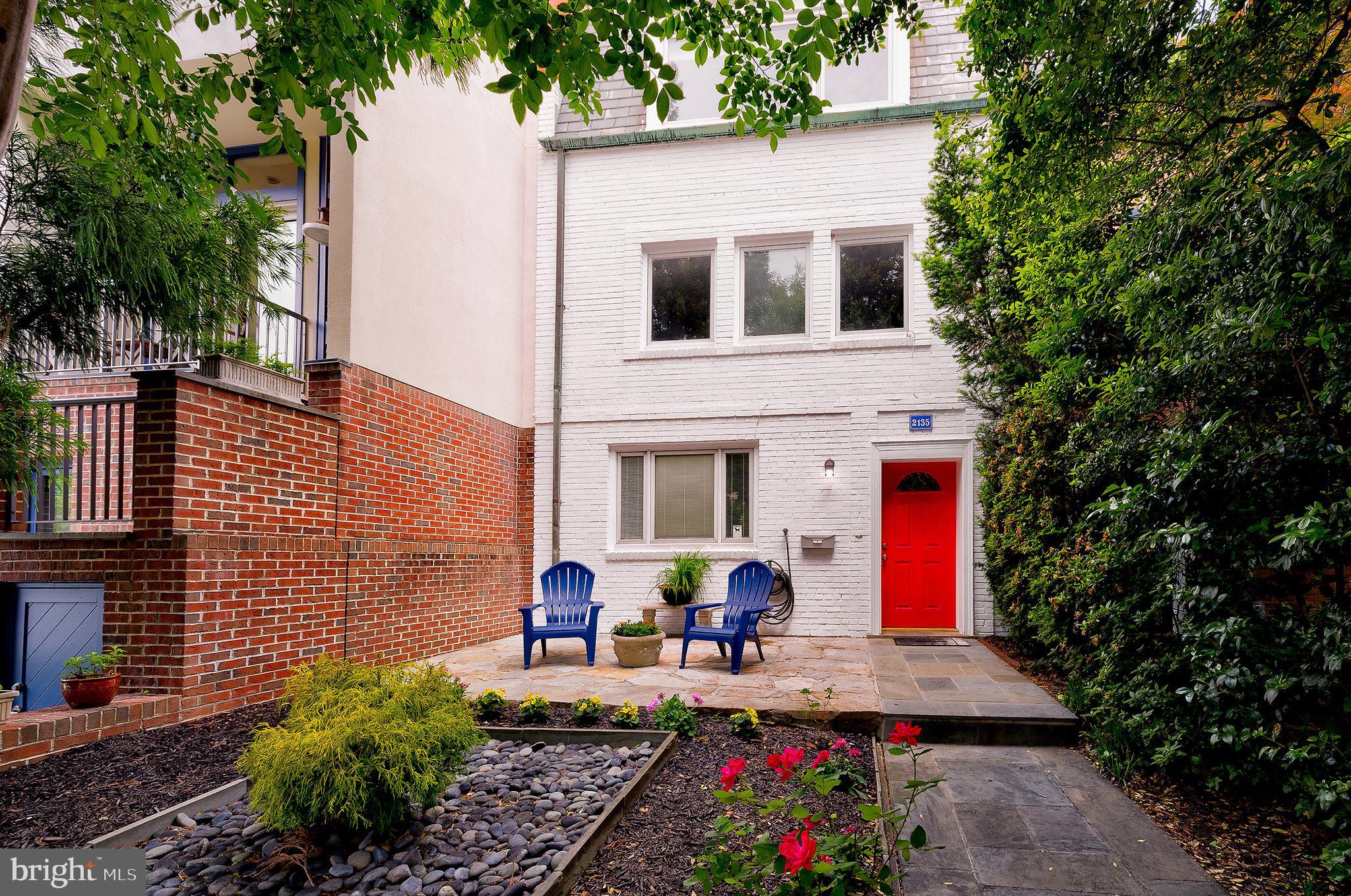 a group of people sitting in front of a house