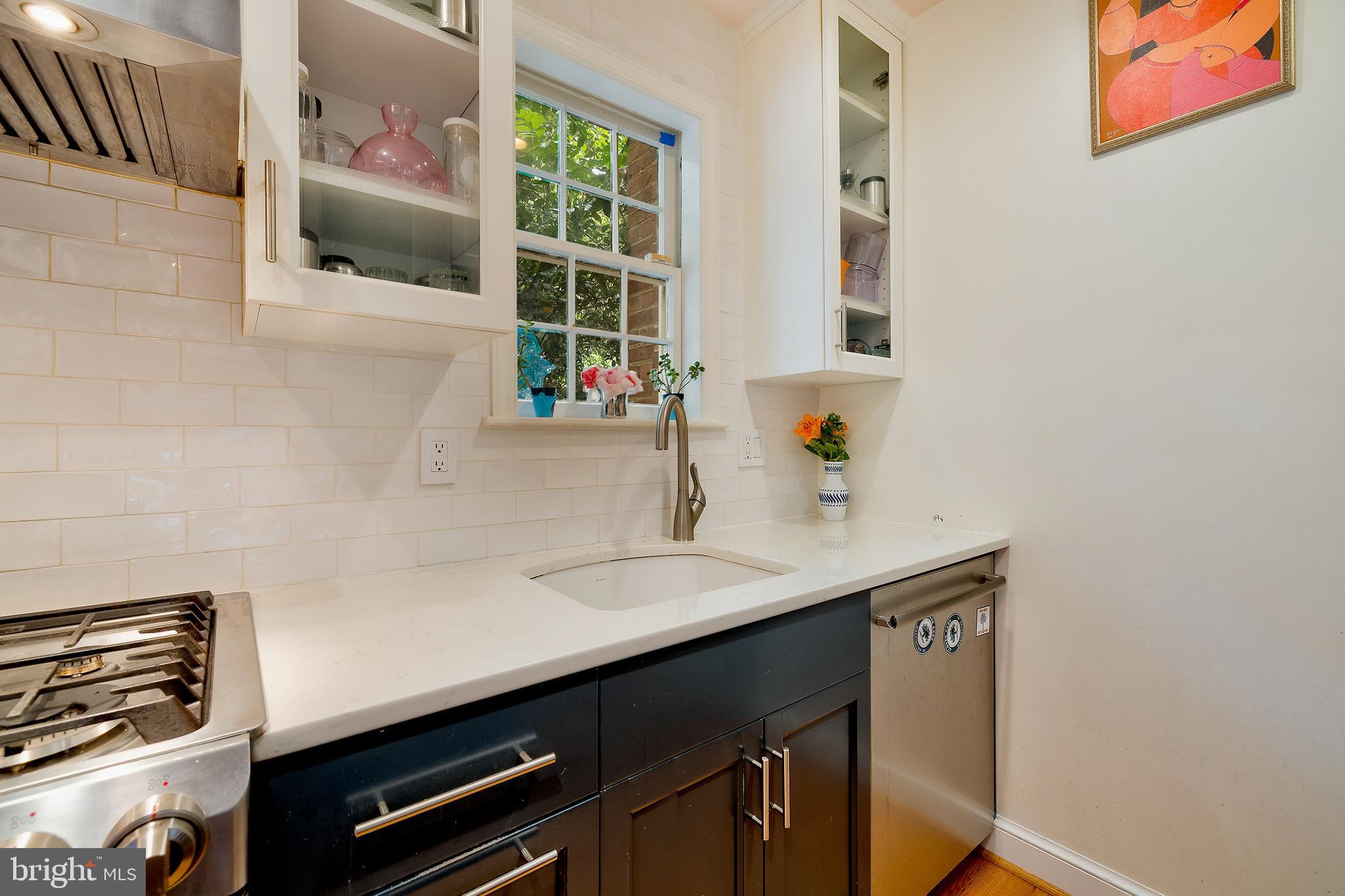 2135 Tunlaw Road Northwest Washington, DC 20007 - Photo 15 of 48 a bathroom with a sink a vanity and a window