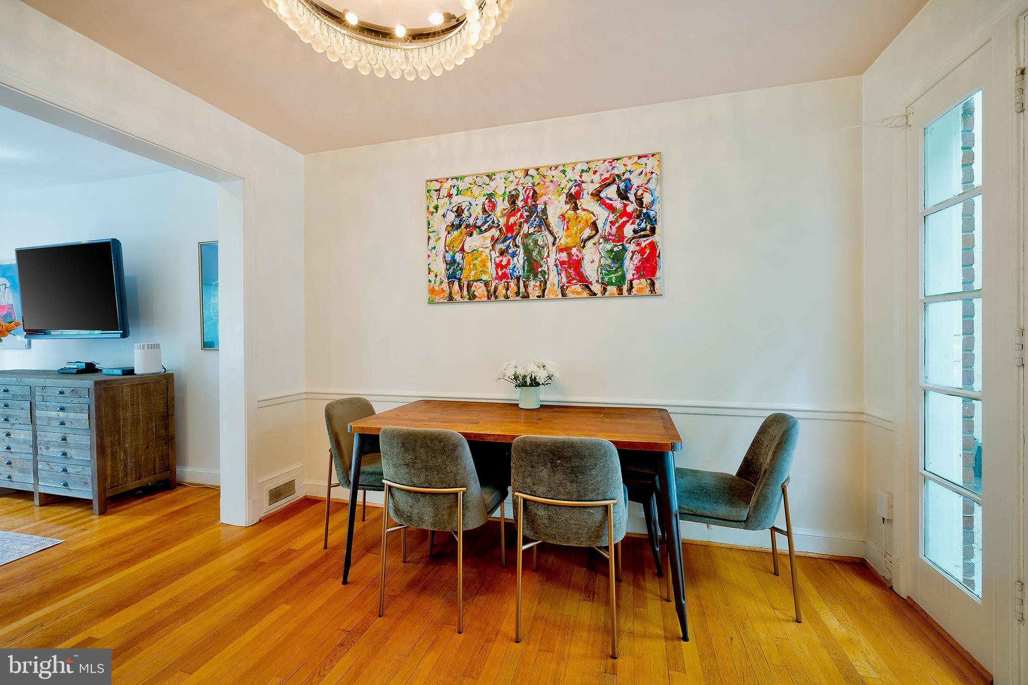 2135 Tunlaw Road Northwest Washington, DC 20007 - Photo 17 of 48 a view of a dining room with furniture and wooden floor