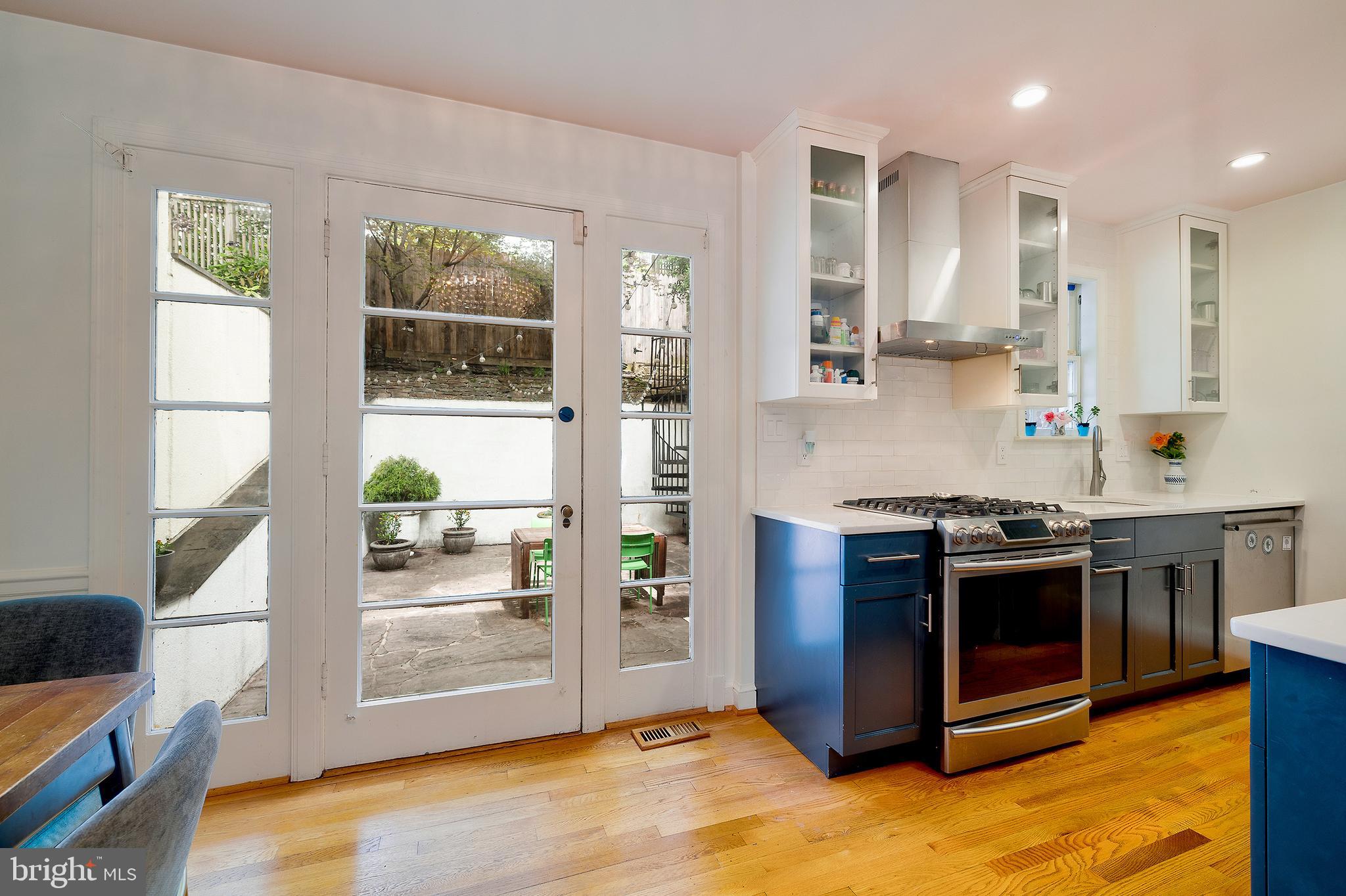 2135 Tunlaw Road Northwest Washington, DC 20007 - Photo 18 of 48 a kitchen with stainless steel appliances granite countertop a stove and a refrigerator