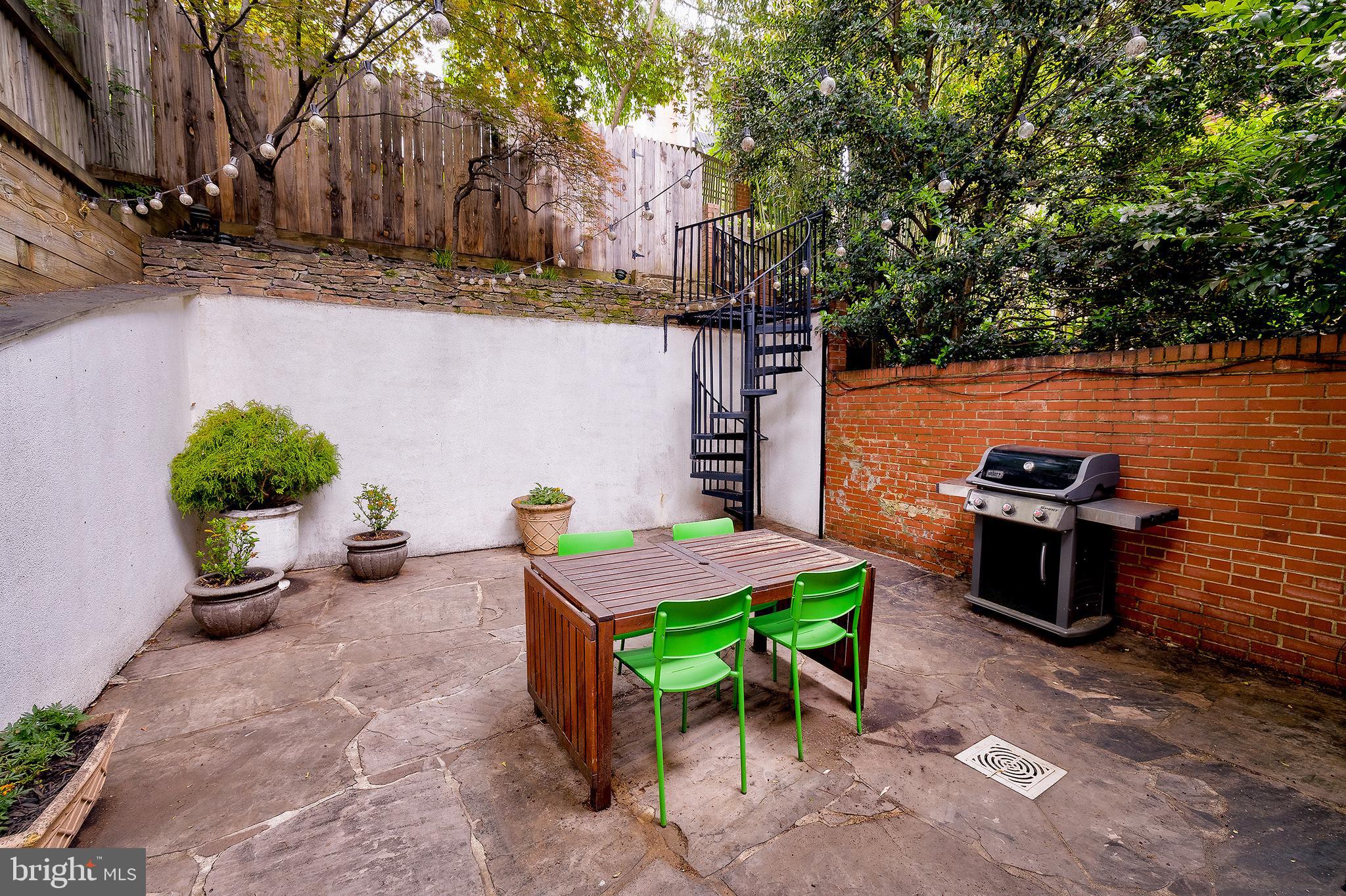 2135 Tunlaw Road Northwest Washington, DC 20007 - Photo 19 of 48 a view of a backyard with sitting area