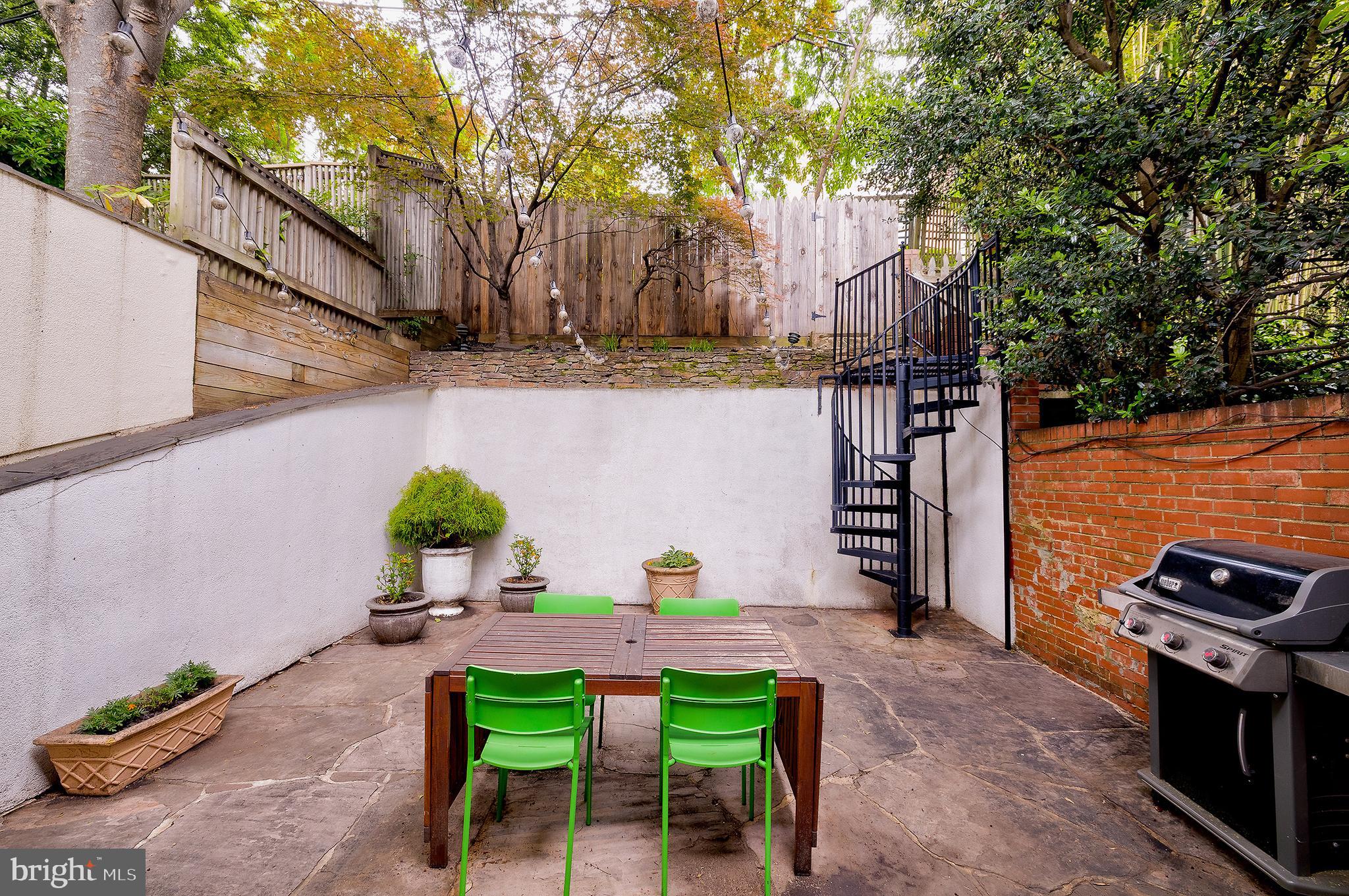 2135 Tunlaw Road Northwest Washington, DC 20007 - Photo 20 of 48 a backyard of a house with table and chairs
