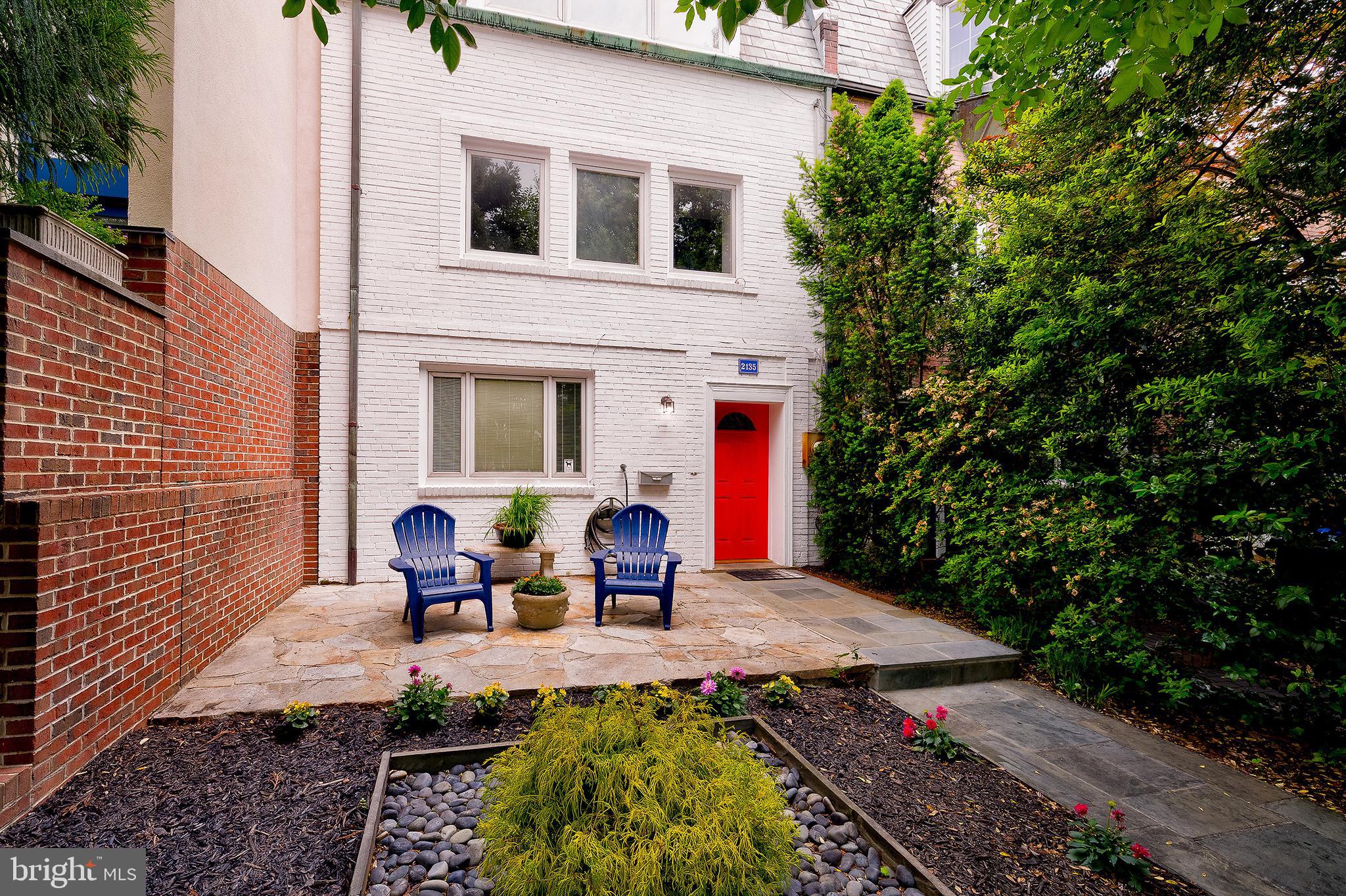 2135 Tunlaw Road Northwest Washington, DC 20007 - Photo 2 of 48 a view of a patio with table and chairs potted plants and floor to ceiling window