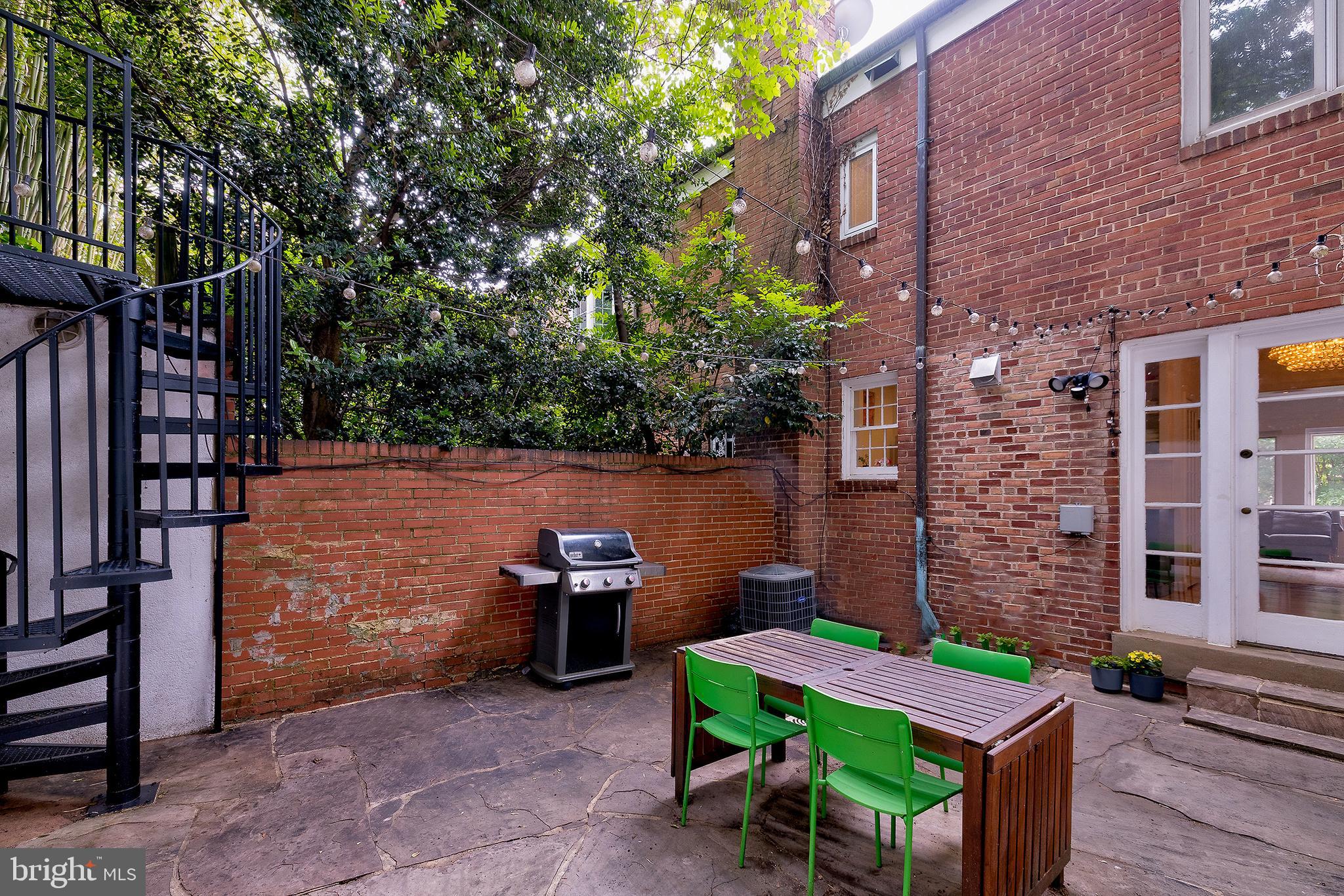 2135 Tunlaw Road Northwest Washington, DC 20007 - Photo 23 of 48 a backyard of a house with outdoor seating