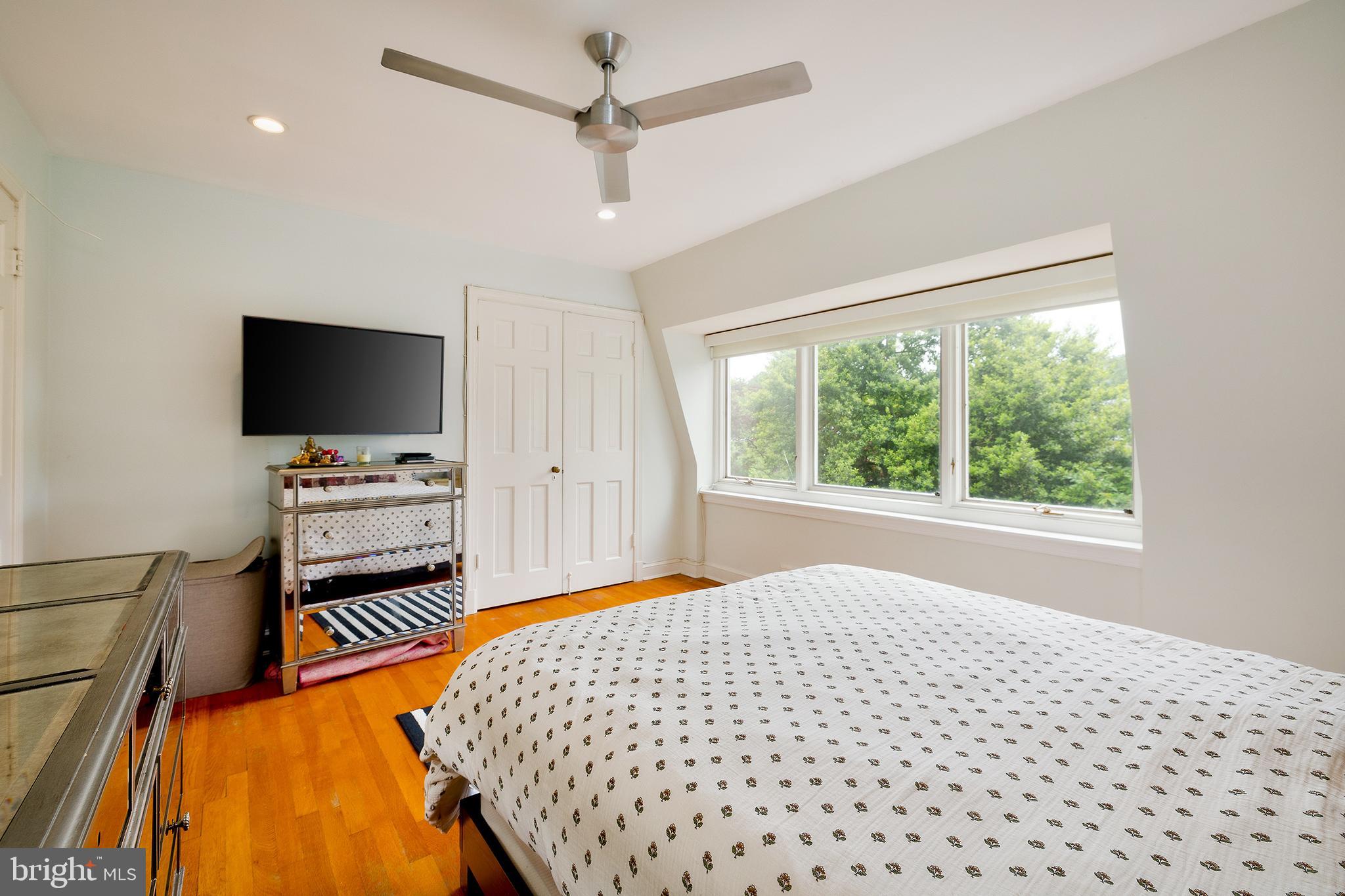 2135 Tunlaw Road Northwest Washington, DC 20007 - Photo 26 of 48 a bedroom with a bed and a flat screen tv