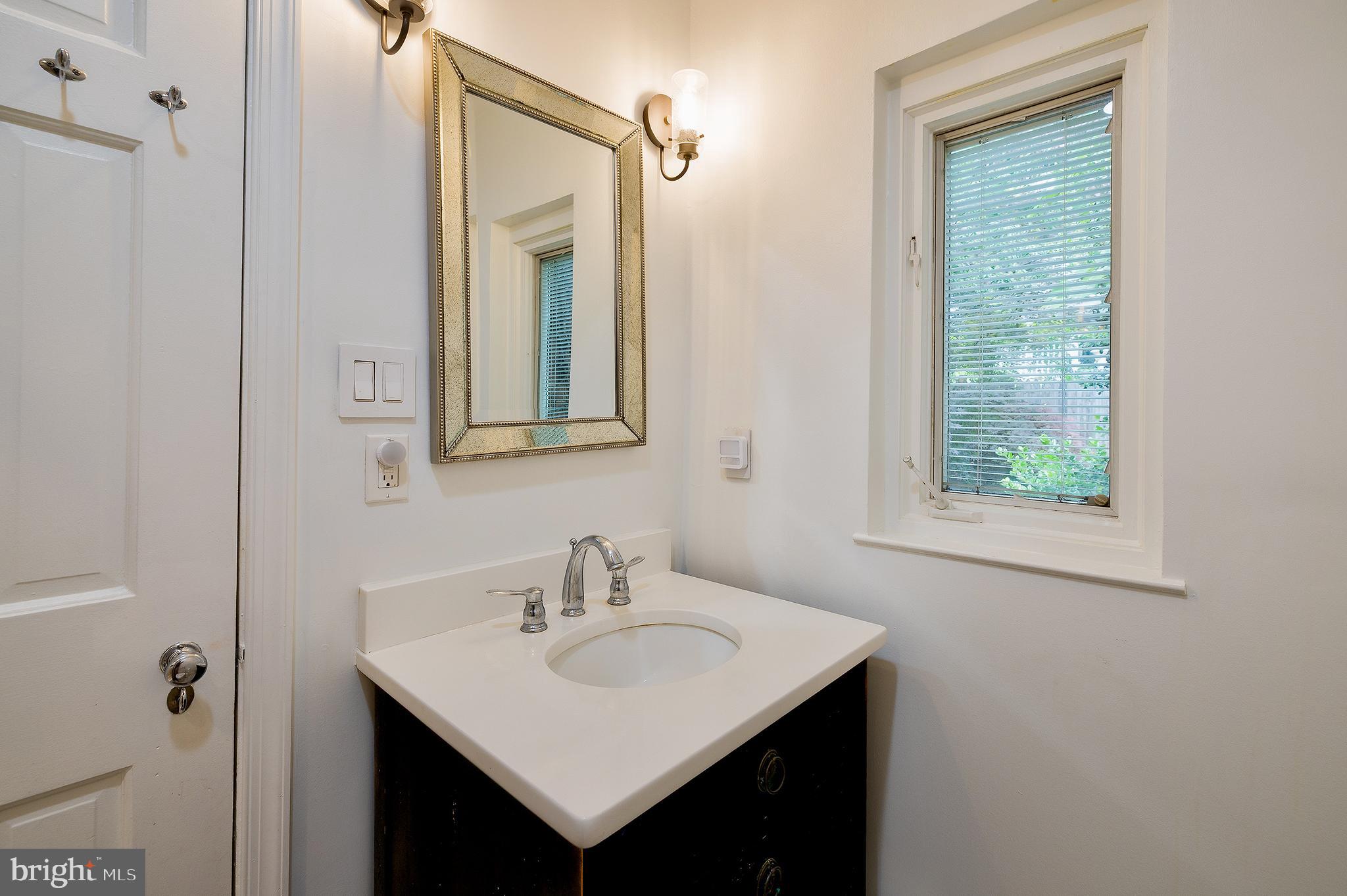 2135 Tunlaw Road Northwest Washington, DC 20007 - Photo 29 of 48 a bathroom with a sink and a mirror