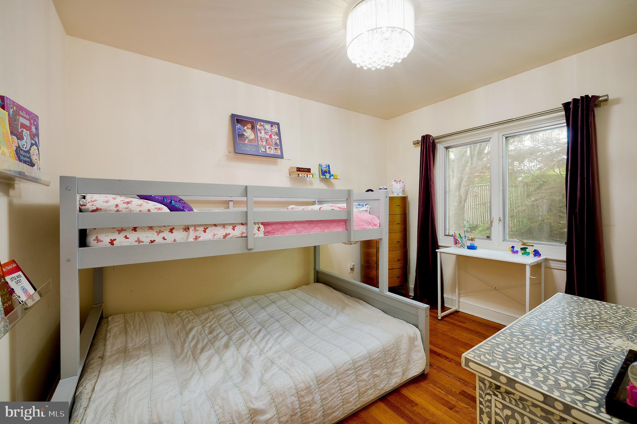 2135 Tunlaw Road Northwest Washington, DC 20007 - Photo 30 of 48 a bedroom with a bed and wooden floor