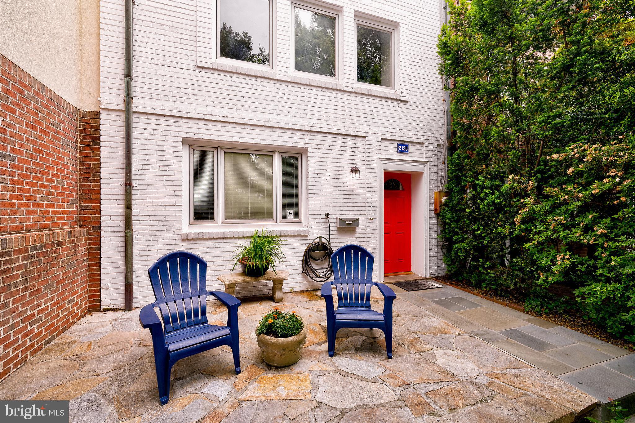 2135 Tunlaw Road Northwest Washington, DC 20007 - Photo 3 of 48 a view of a chair and tables in the back yard of the house