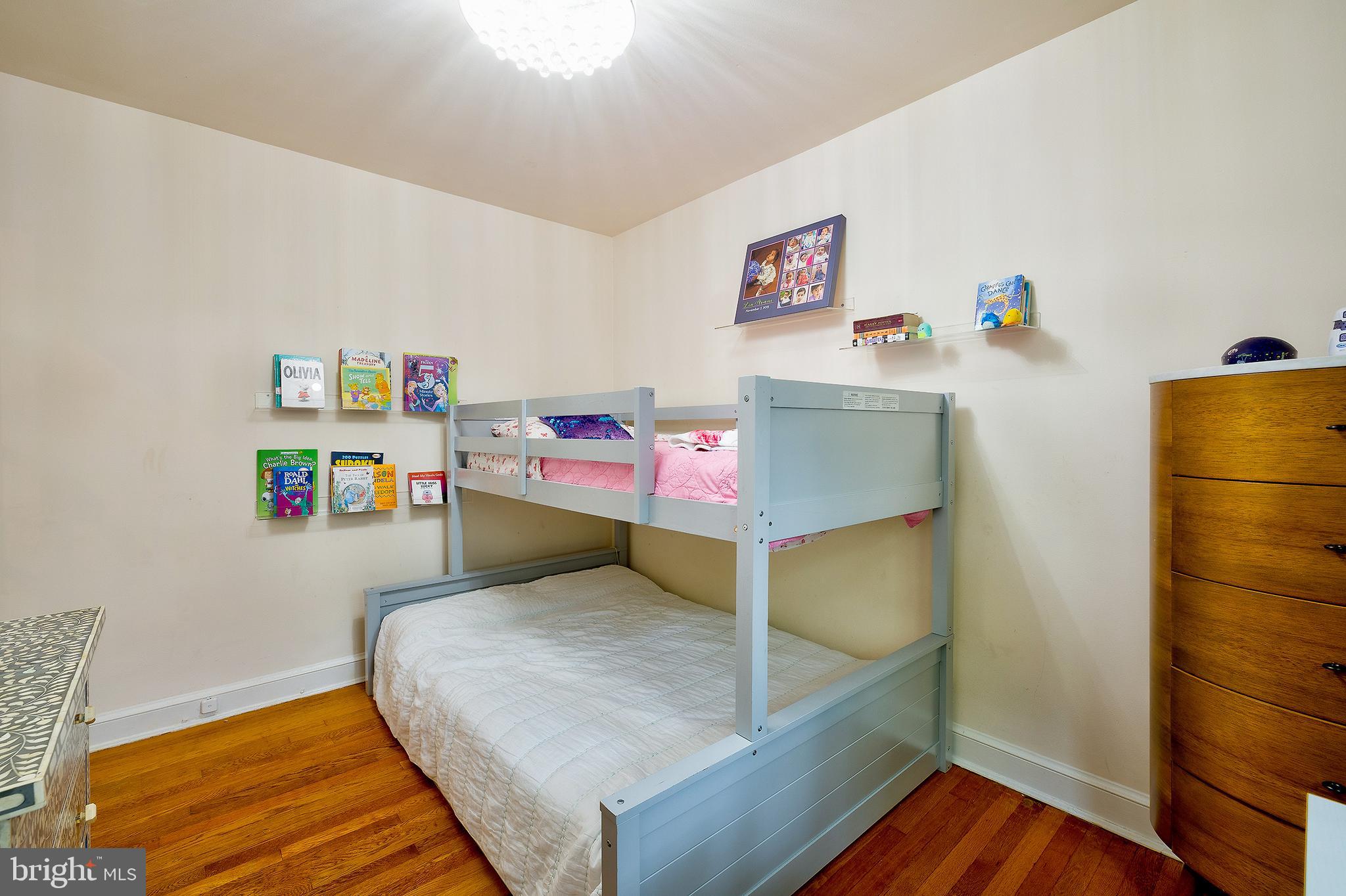 2135 Tunlaw Road Northwest Washington, DC 20007 - Photo 31 of 48 a bedroom with a bed and wooden floor