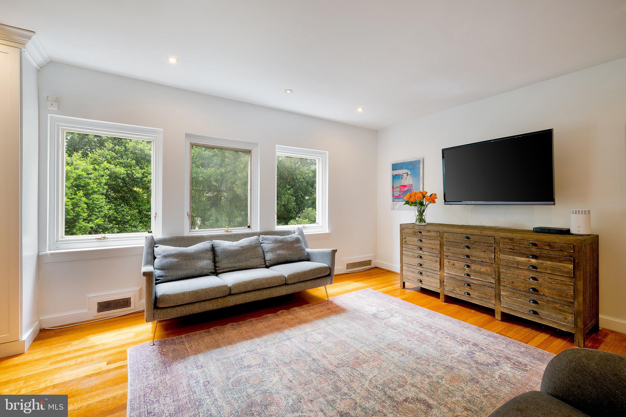2135 Tunlaw Road Northwest Washington, DC 20007 - Photo 5 of 48 a living room with furniture and a flat screen tv