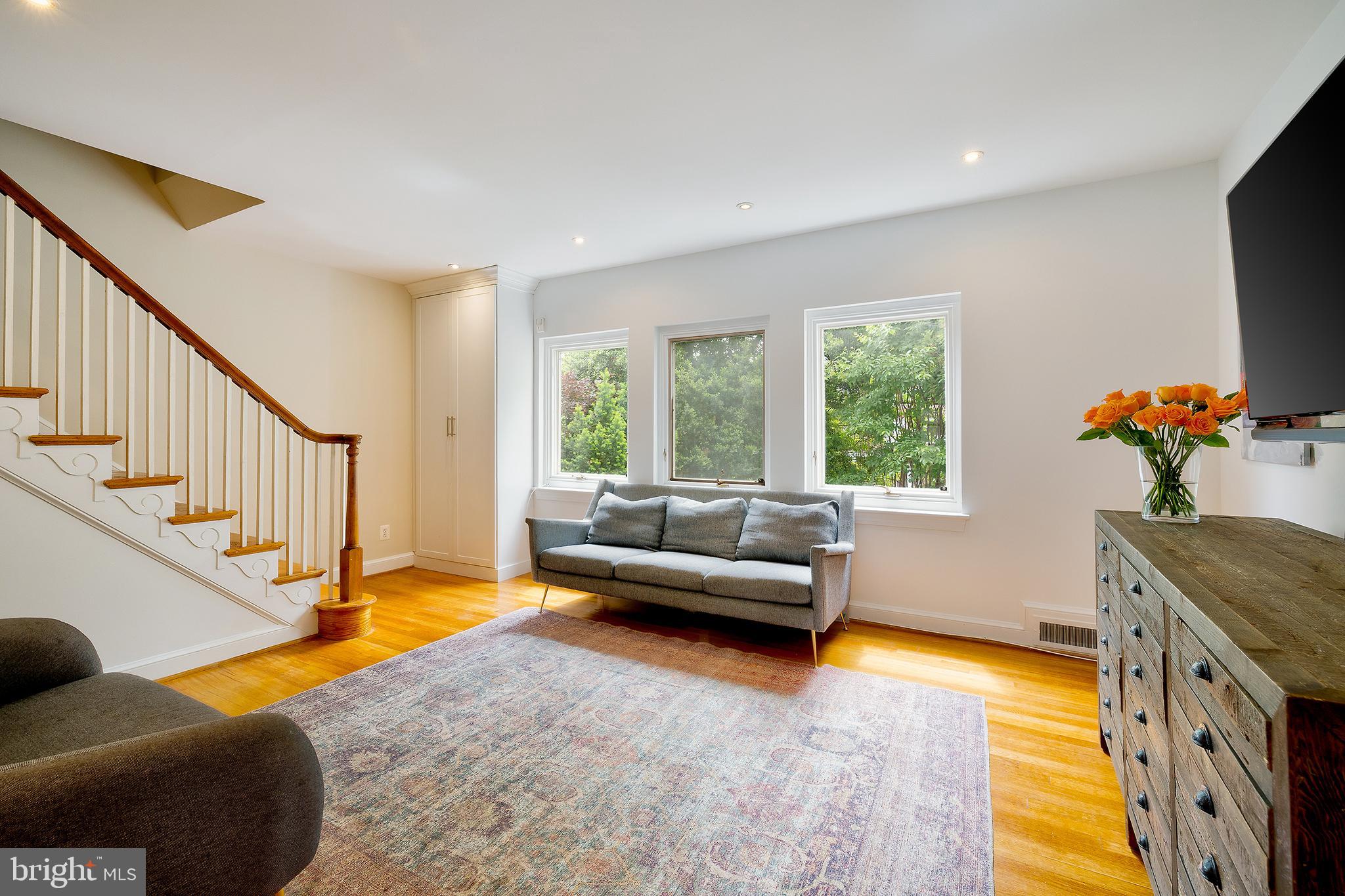 2135 Tunlaw Road Northwest Washington, DC 20007 - Photo 6 of 48 a living room with furniture and a flat screen tv