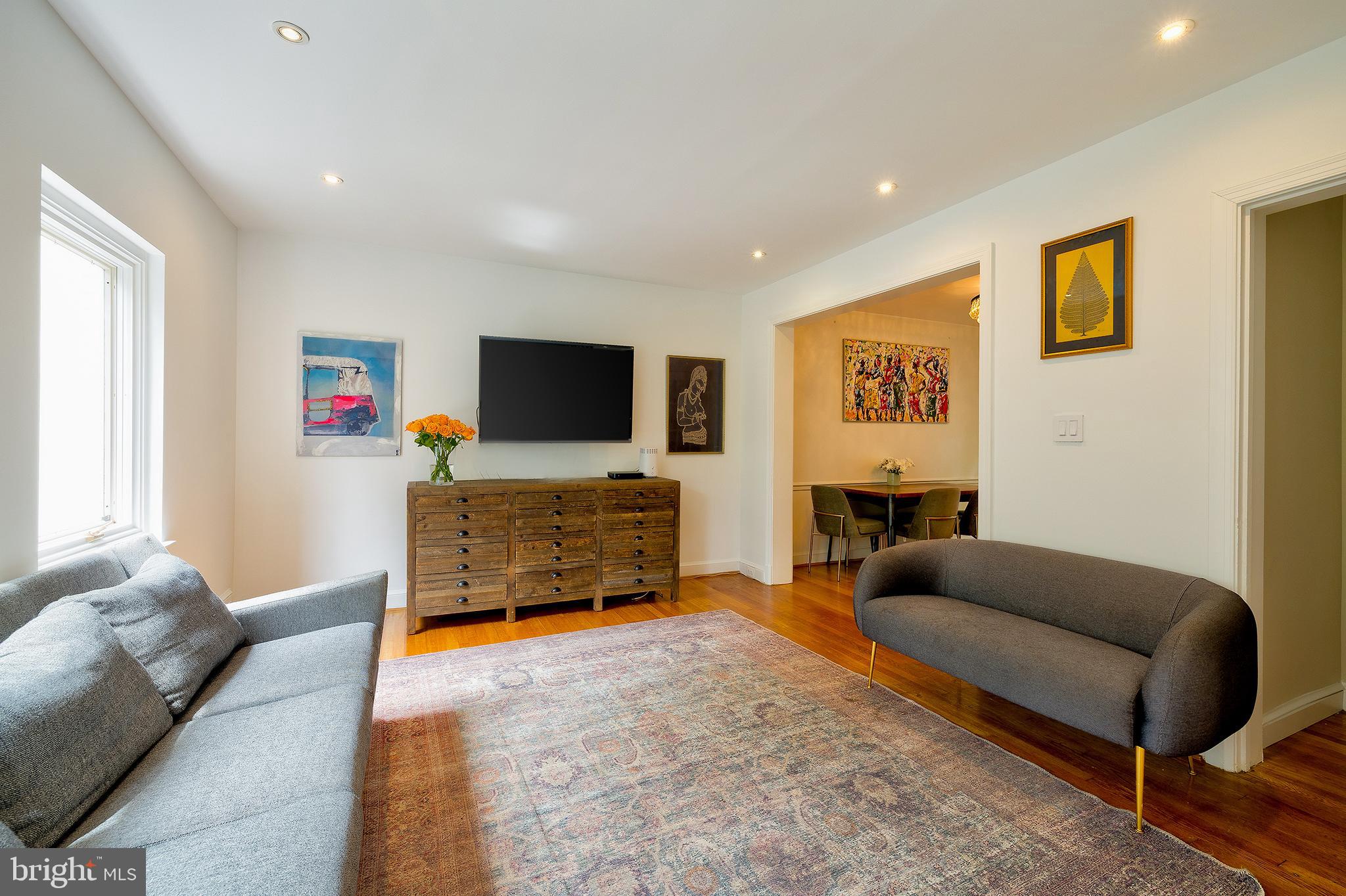 2135 Tunlaw Road Northwest Washington, DC 20007 - Photo 7 of 48 a living room with furniture and a flat screen tv