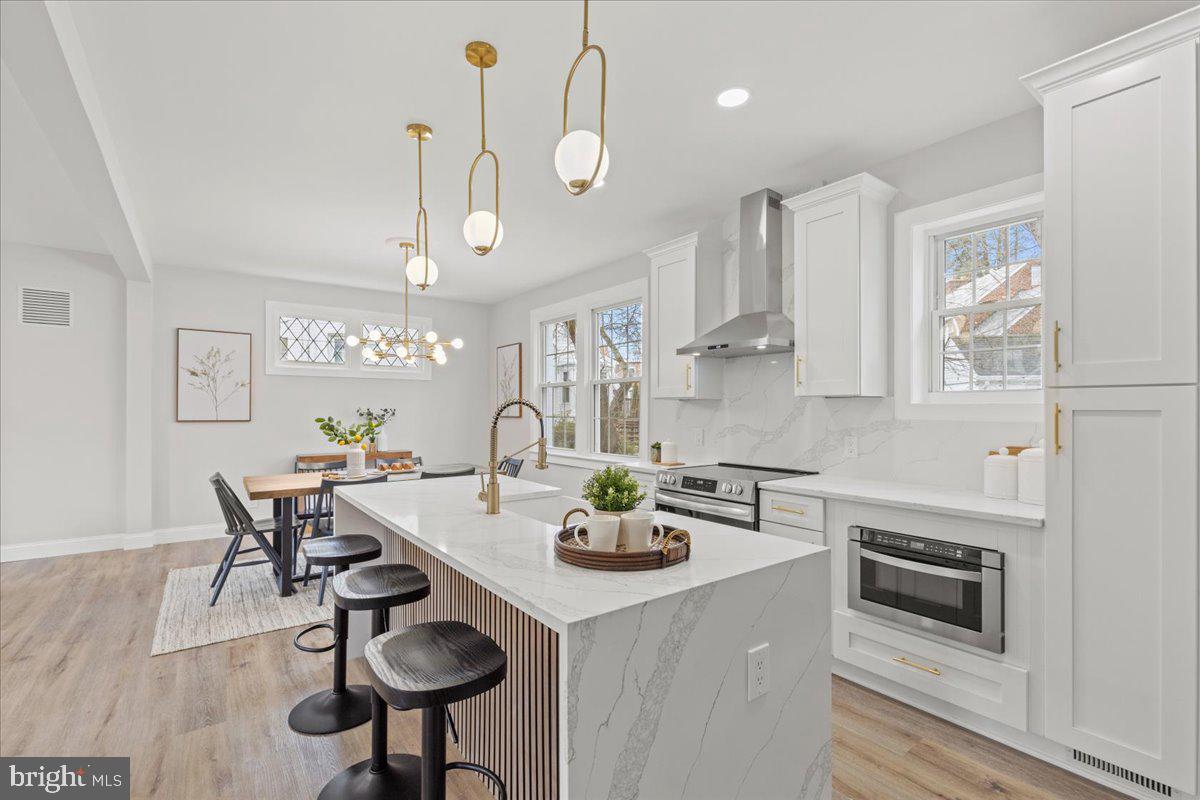 1705 Corwin Drive Silver Spring, MD 20910 - Photo 13 of 38 a kitchen with stainless steel appliances a dining table chairs and wooden floor