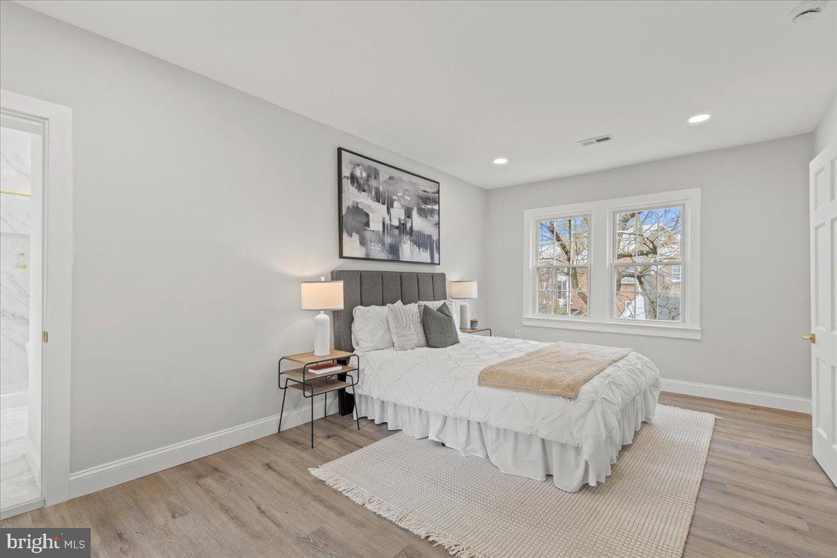 1705 Corwin Drive Silver Spring, MD 20910 - Photo 16 of 38 a bedroom with a bed and a painting on the wall