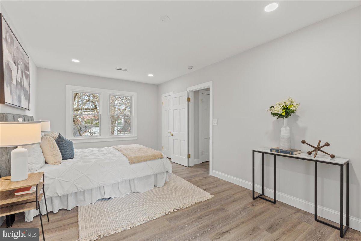 1705 Corwin Drive Silver Spring, MD 20910 - Photo 18 of 38 a bedroom with a large bed chandelier and a window