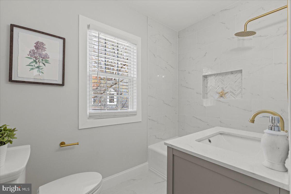 1705 Corwin Drive Silver Spring, MD 20910 - Photo 25 of 38 a bathroom with a toilet sink and mirror