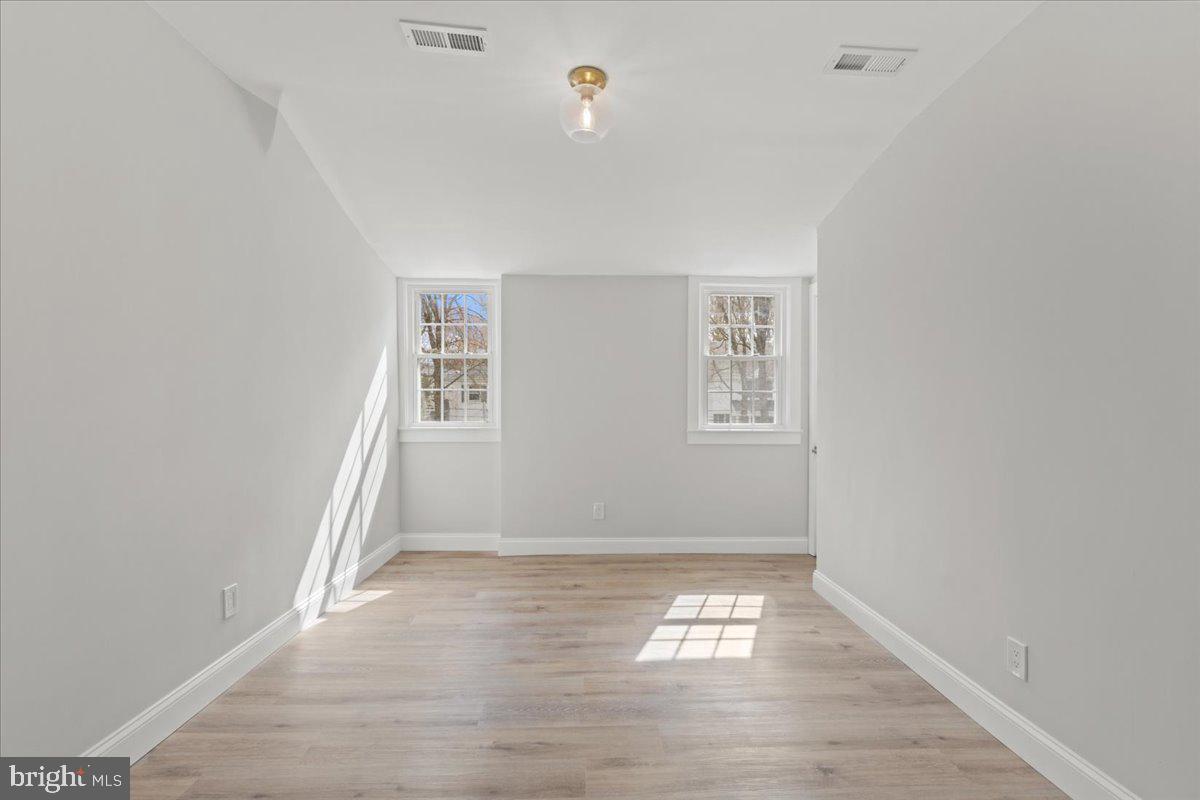 1705 Corwin Drive Silver Spring, MD 20910 - Photo 27 of 38 an empty room with wooden floor and windows