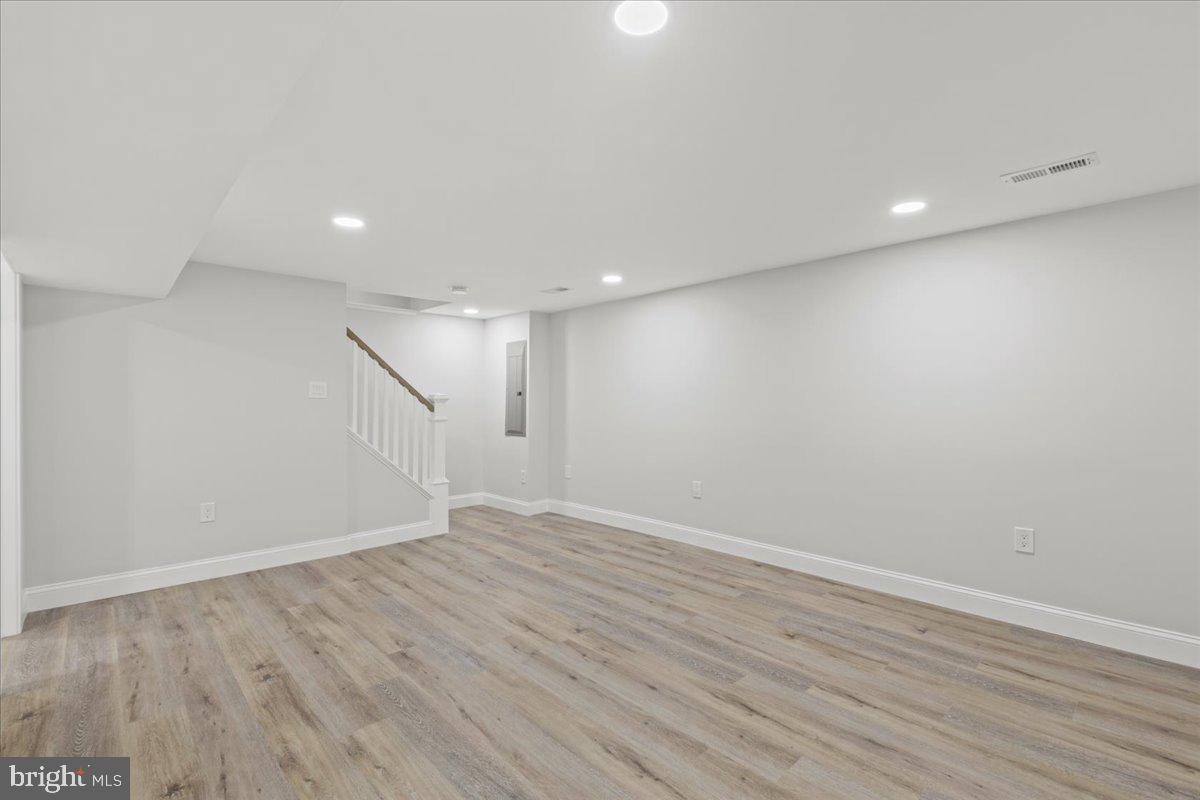 1705 Corwin Drive Silver Spring, MD 20910 - Photo 29 of 38 an empty room with wooden floor and white walls