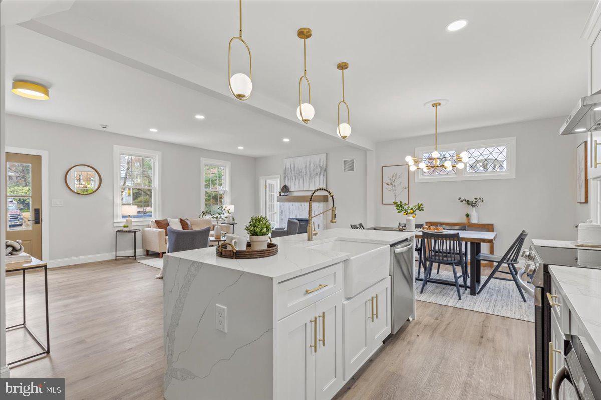 1705 Corwin Drive Silver Spring, MD 20910 - Photo 10 of 38 a large kitchen with kitchen island a island a sink a stove a dining table and chairs