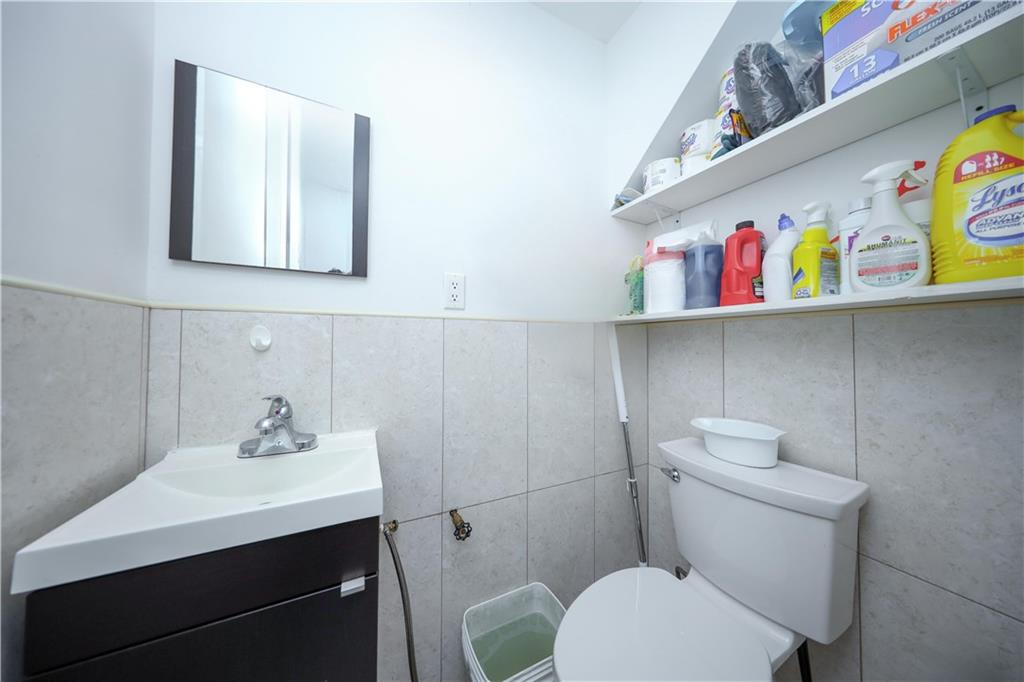 2046 Stuart Street Brooklyn, NY 11229 - Photo 11 of 27 a bathroom with a sink a toilet and vanity
