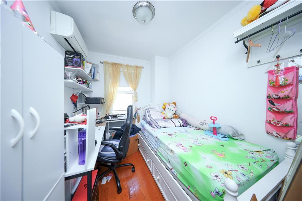 2046 Stuart Street Brooklyn, NY 11229 - Photo 14 of 27 a bed room with a bed and a baby crib