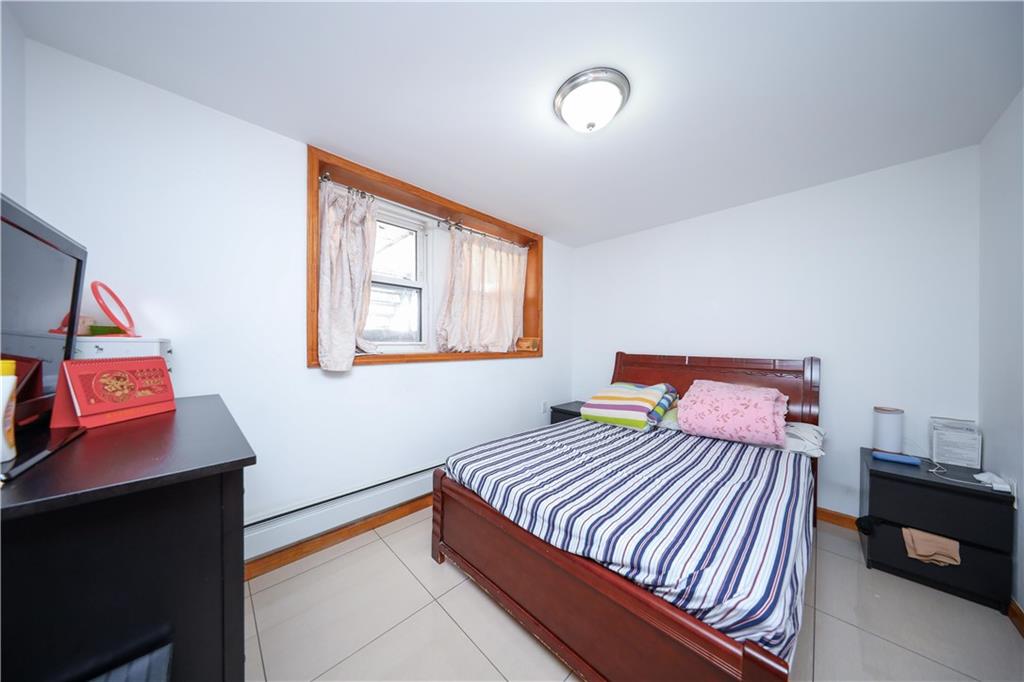 2046 Stuart Street Brooklyn, NY 11229 - Photo 17 of 27 a bedroom with a bed and a night stand