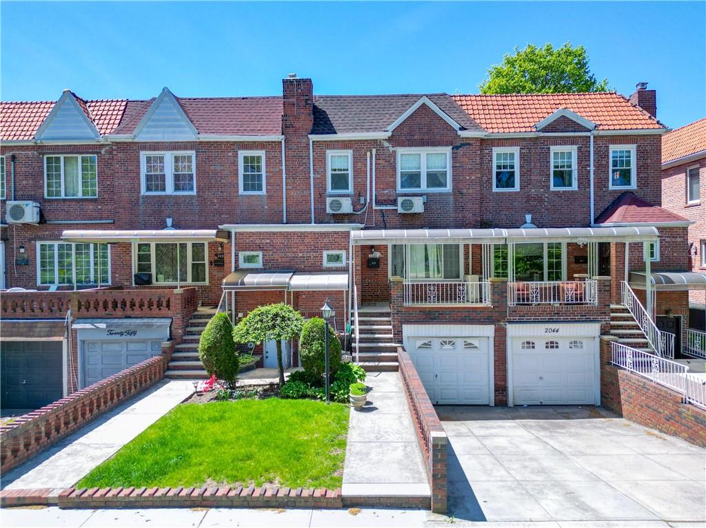 2046 Stuart Street Brooklyn, NY 11229 - Photo 20 of 27 a view of a brick house with a yard plants and a table and chairs