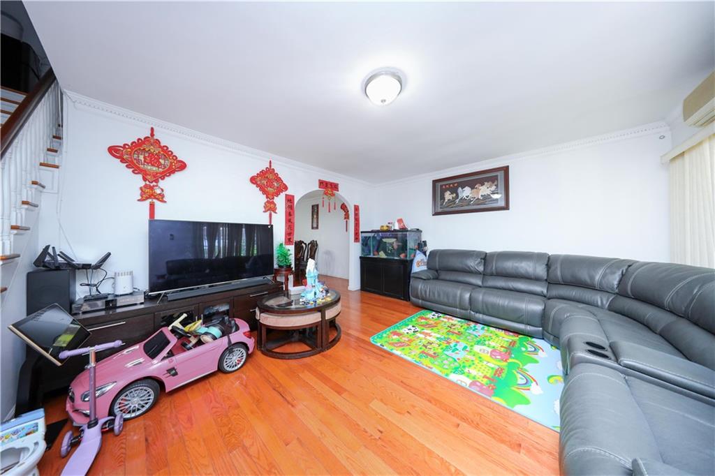 2046 Stuart Street Brooklyn, NY 11229 - Photo 7 of 27 a living room with furniture a flat screen tv and a fireplace