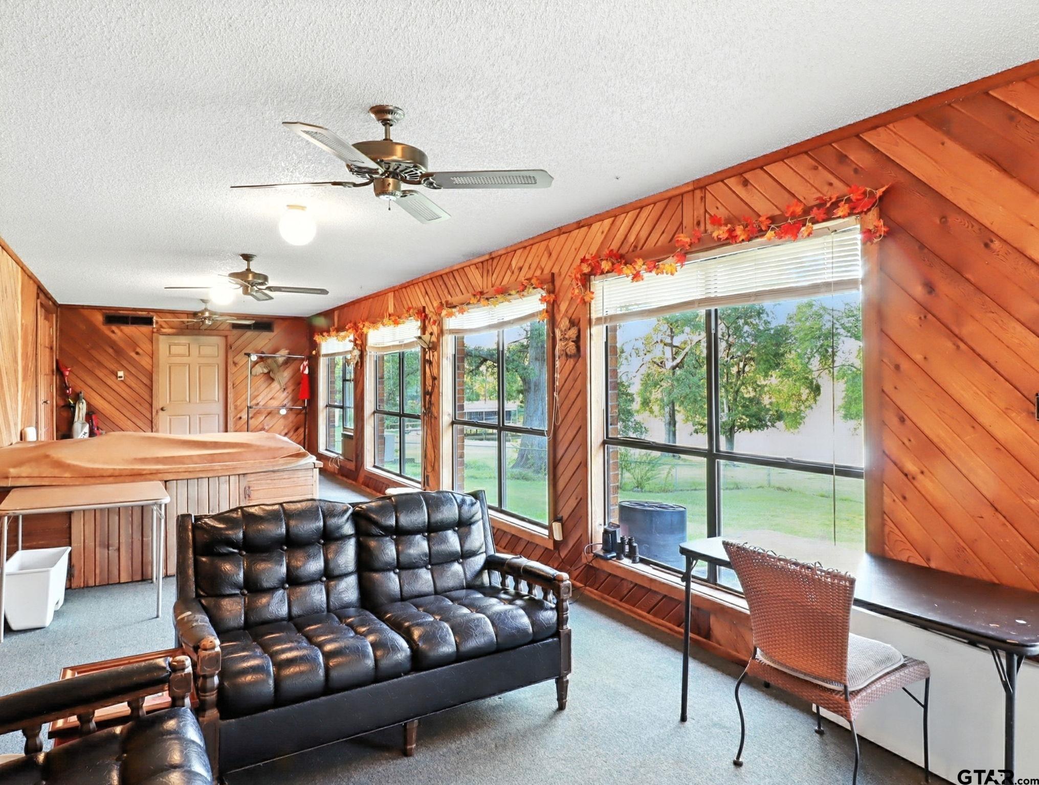 402 Watson Road Gladewater, TX 75647 - Photo 12 of 32 a bedroom with furniture and a large window