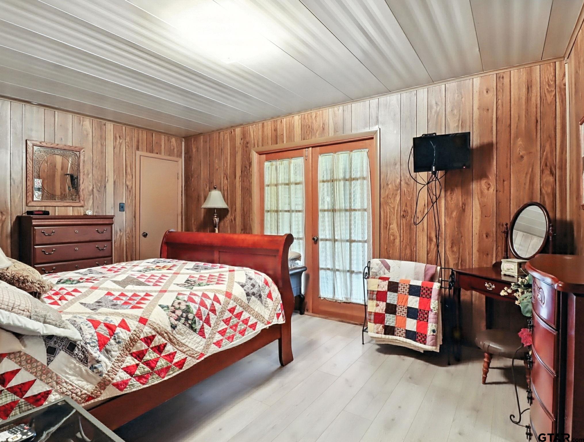 402 Watson Road Gladewater, TX 75647 - Photo 14 of 32 a bedroom with a bed closet and a window