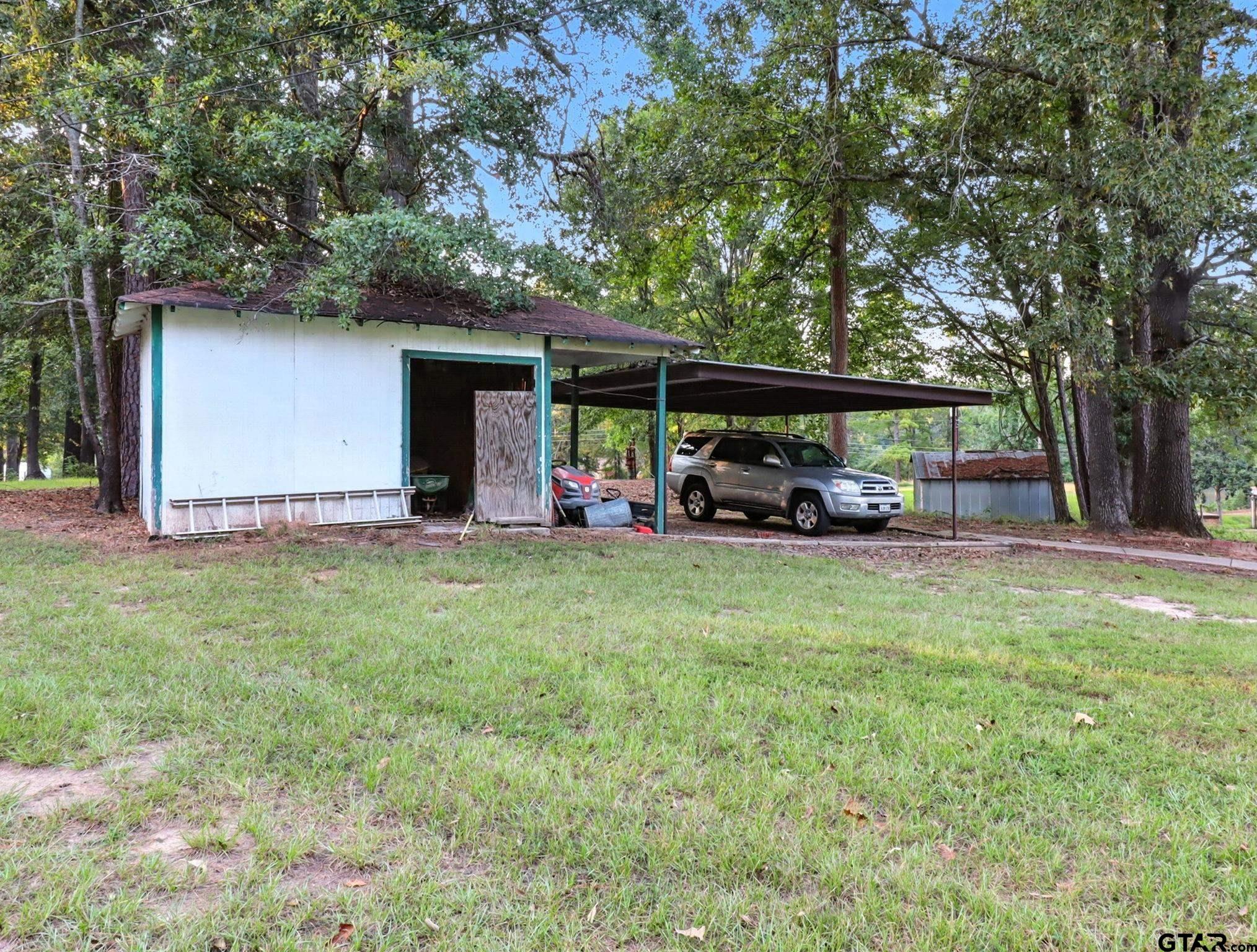 402 Watson Road Gladewater, TX 75647 - Photo 25 of 32 a view of a house with backyard and porch