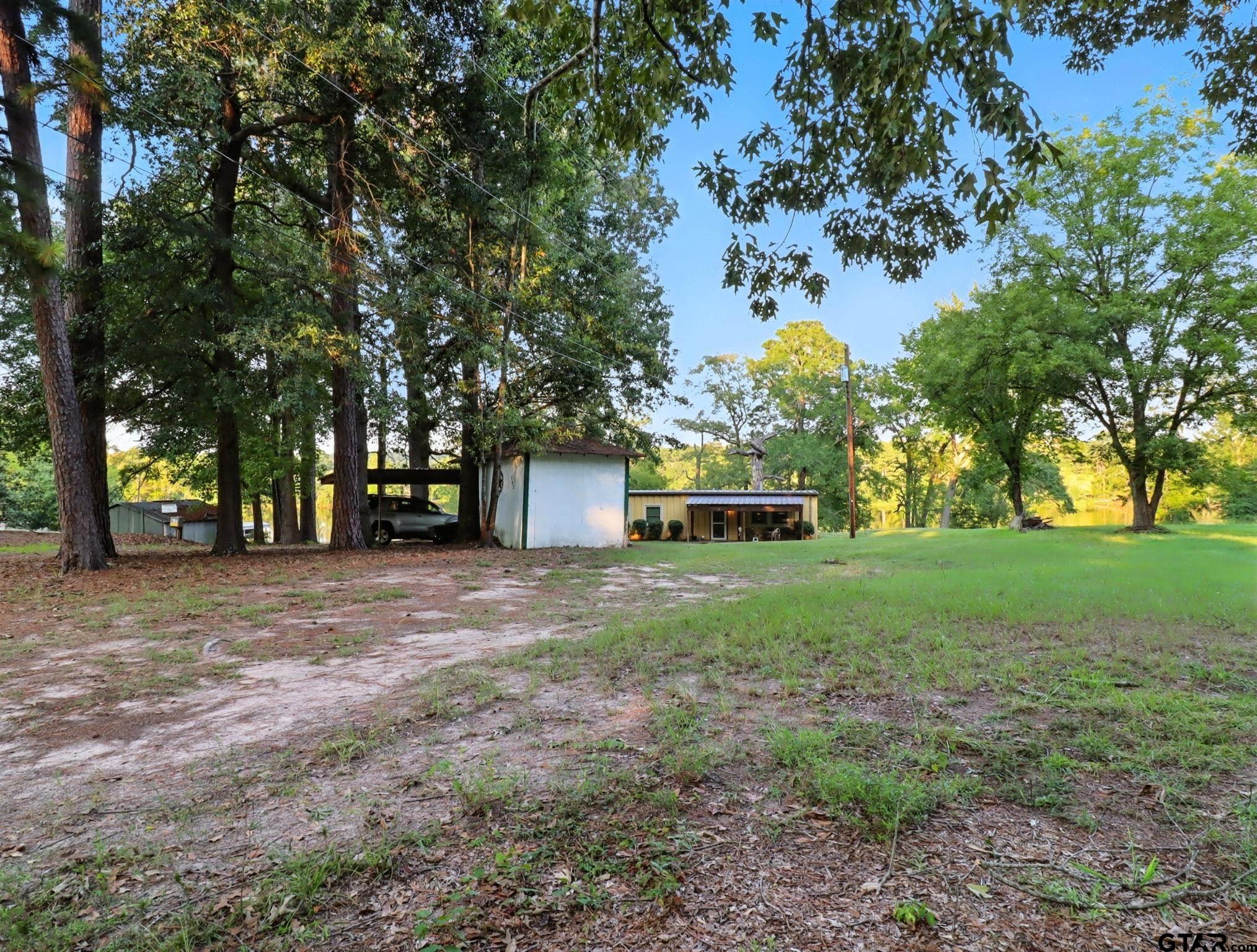 402 Watson Road Gladewater, TX 75647 - Photo 28 of 32 a front view of a house with garden