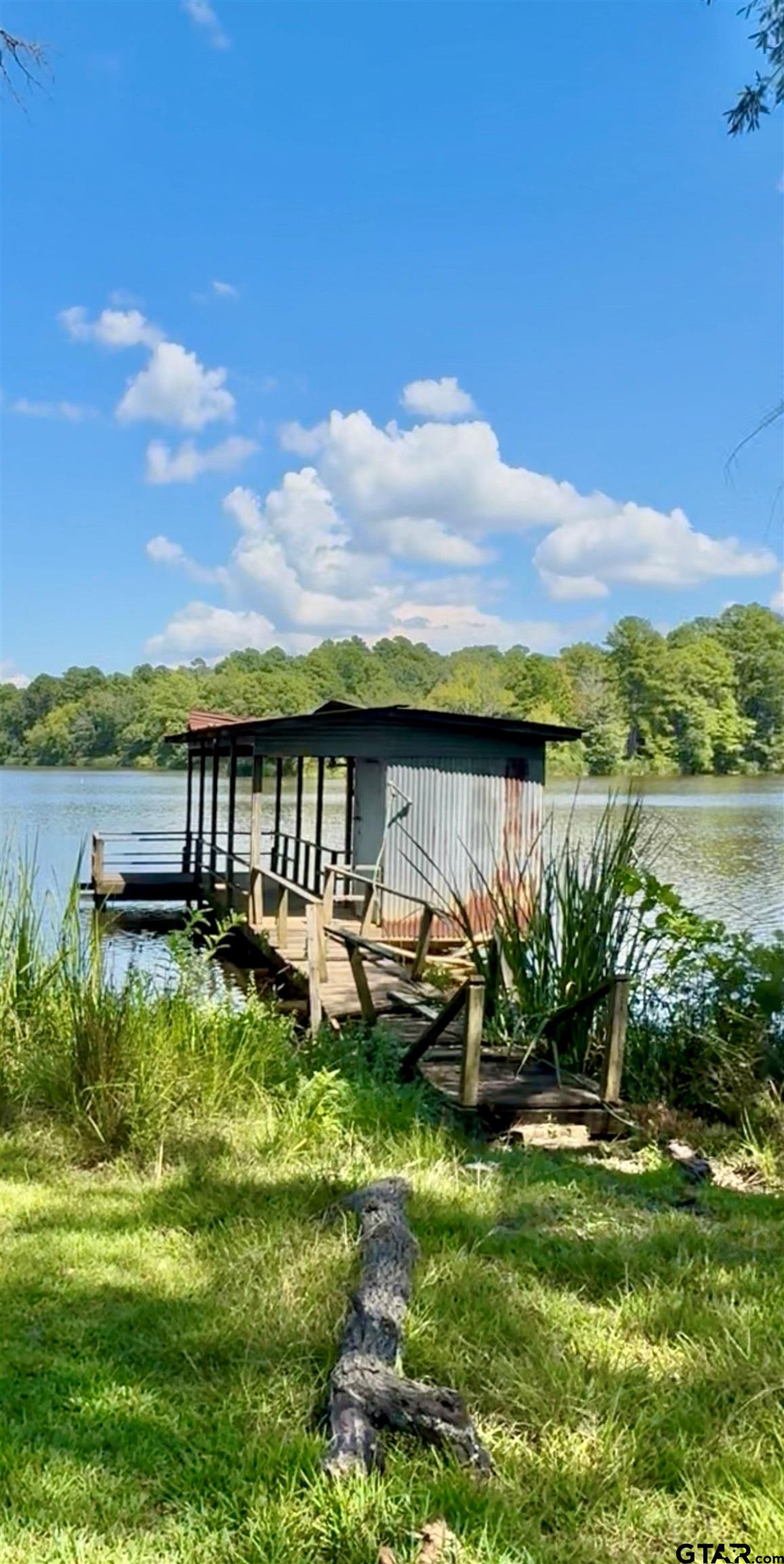 402 Watson Road Gladewater, TX 75647 - Photo 30 of 32 a view of a lake with couches in the patio
