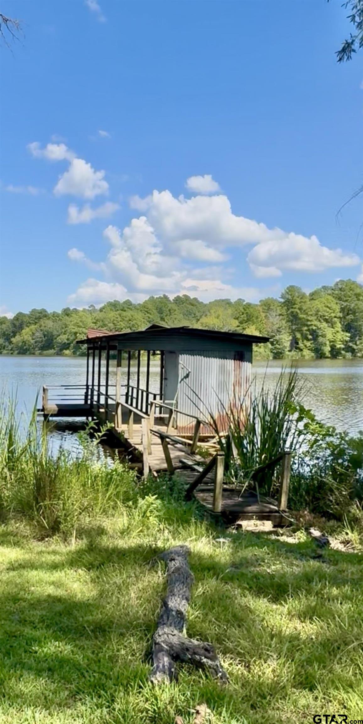 402 Watson Road Gladewater, TX 75647 - Photo 32 of 32 a view of a lake with couches in the patio