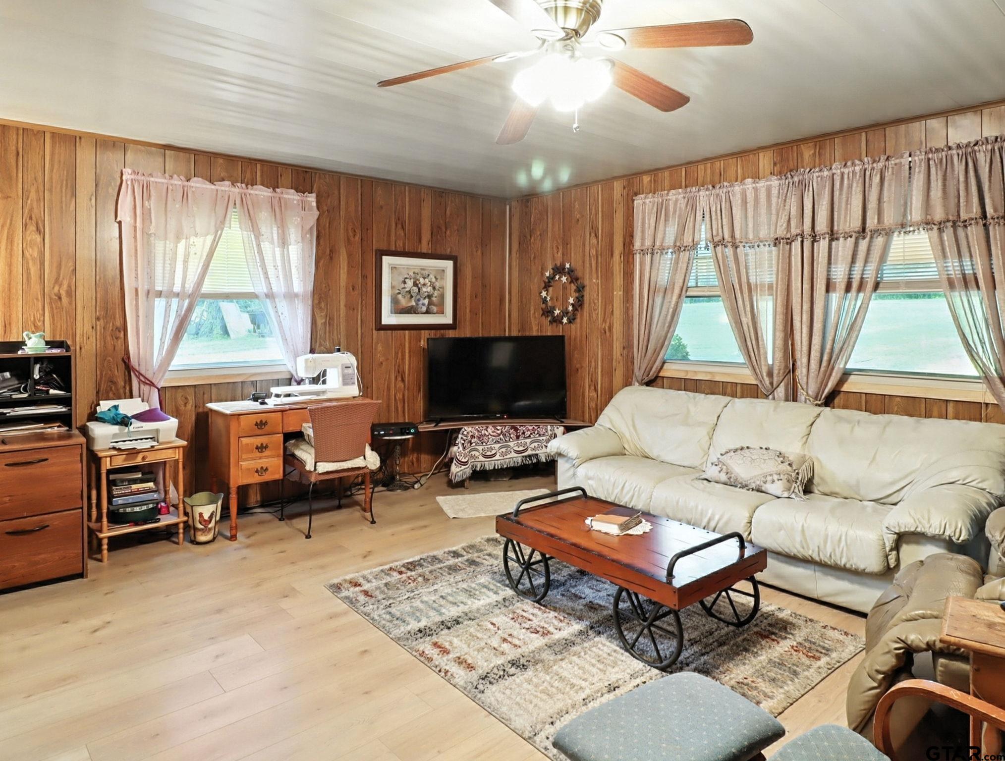 402 Watson Road Gladewater, TX 75647 - Photo 4 of 32 a living room with furniture a large window and a flat screen tv